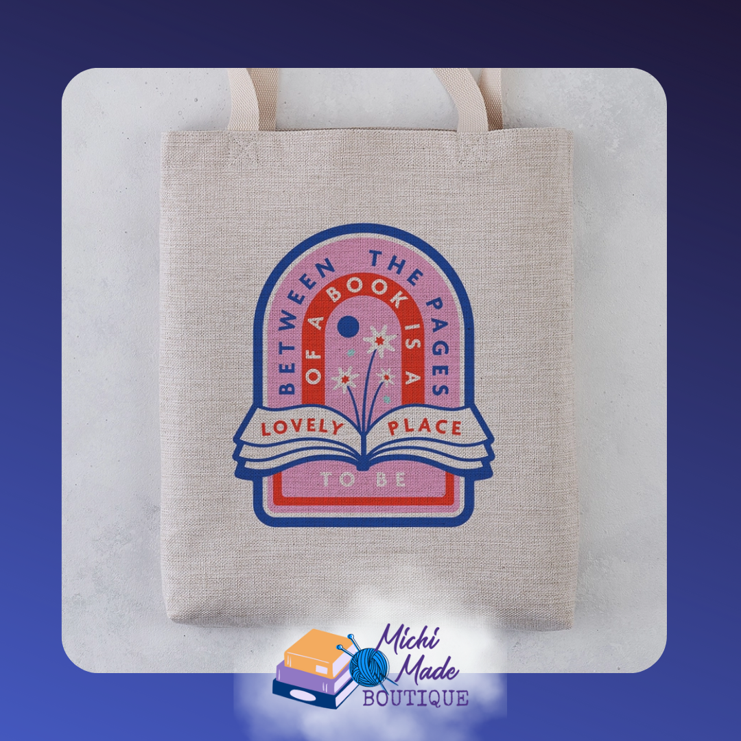 Canvas tote reading “Between the Pages of a Book is a Lovely Place to Be” in whimsical font.