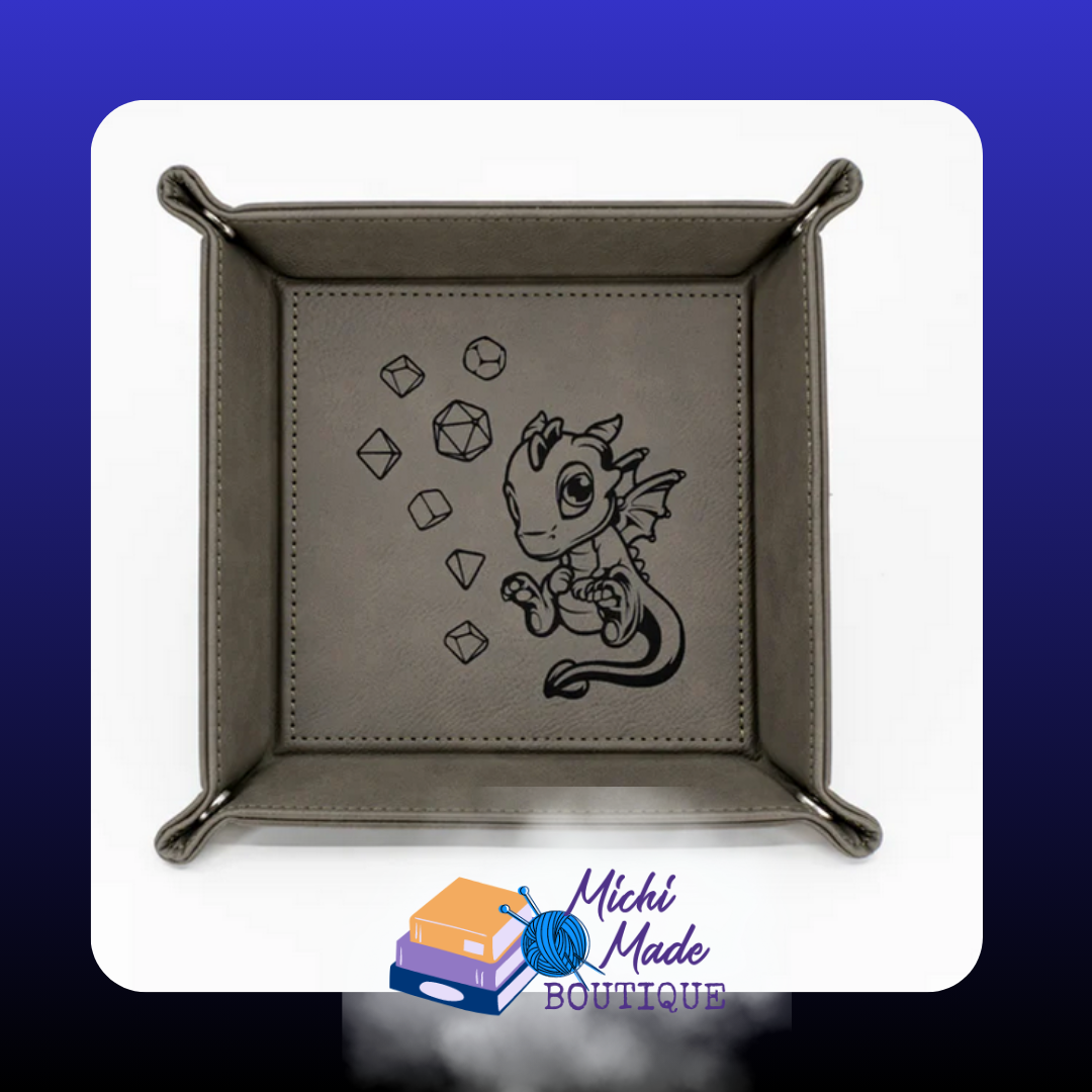 Grey tray with engraved baby dragon surrounded by dice.