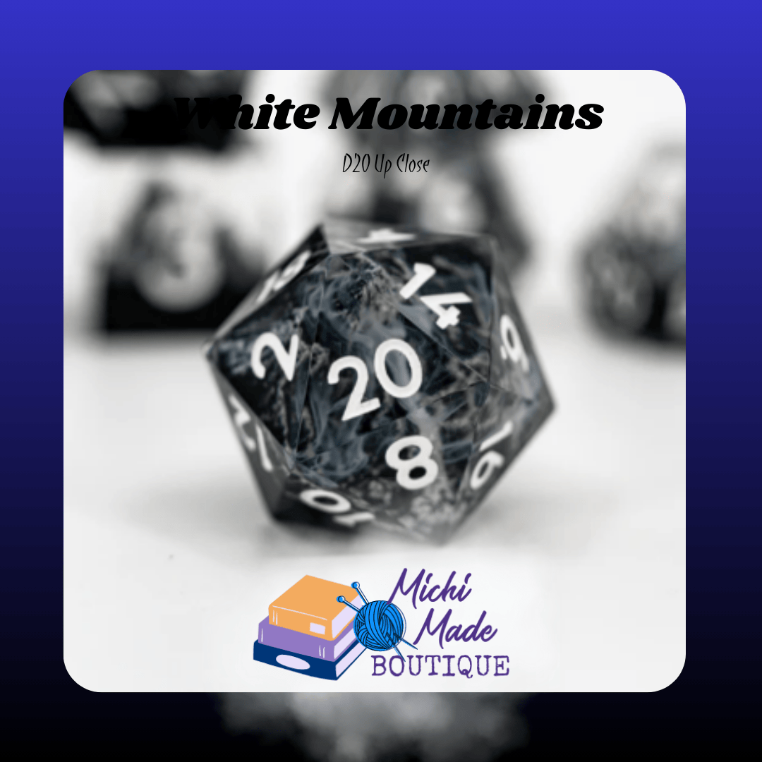 White Mountains – D20 Up Close — Close-up d20 with swirling gray clouds and white numerals over dark peaks.