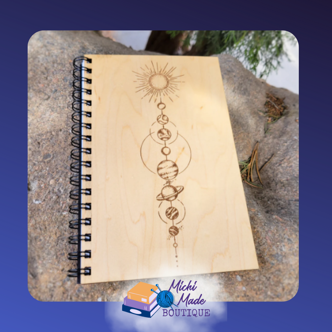 Solar System – Wood journal with engraved vertical alignment of the sun and planets in fine celestial detail.