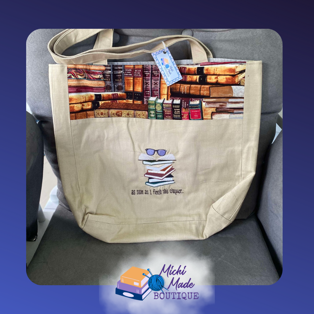 As Soon As I Finish this Chapter Tote Bag. Natural beige tote bag with antique bookshelf fabric panel w/a stack of books with glasses embroidered above the phrase as soon as I finish this chapter