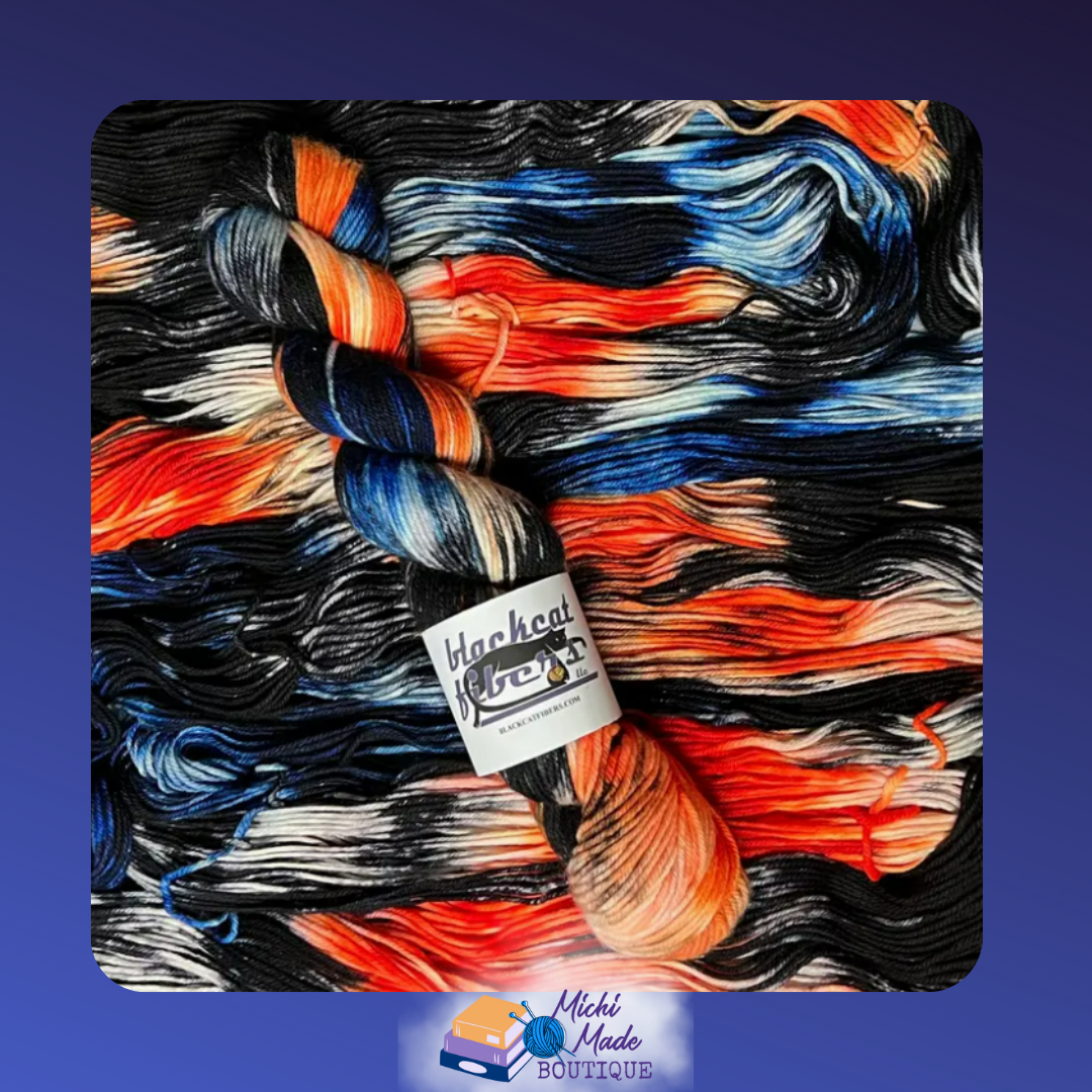 Helix Nebula.png — Swirling black, orange, and blue yarn skein, cosmic galaxy effect.
