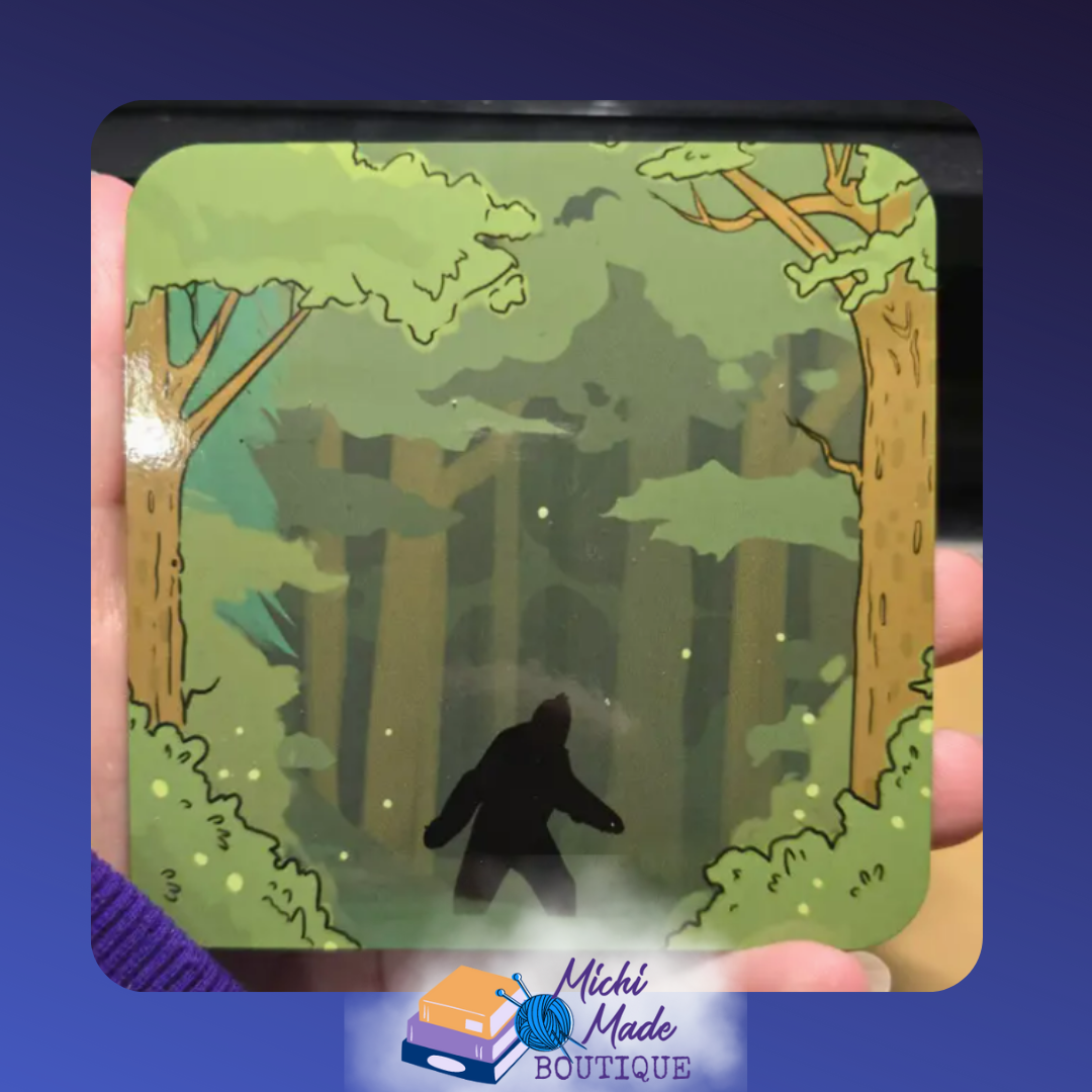 Illustrated wooden coaster with Bigfoot silhouette walking in a dense green forest.