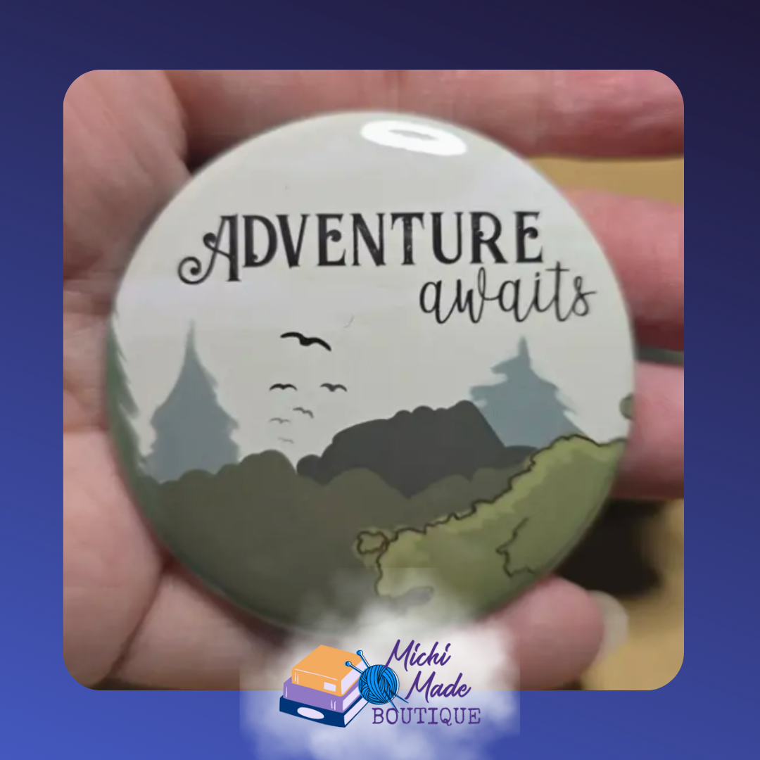 Adventure Awaits Fridge Magnet – Round magnet with “Adventure Awaits” text over a scenic forest and mountain illustration.