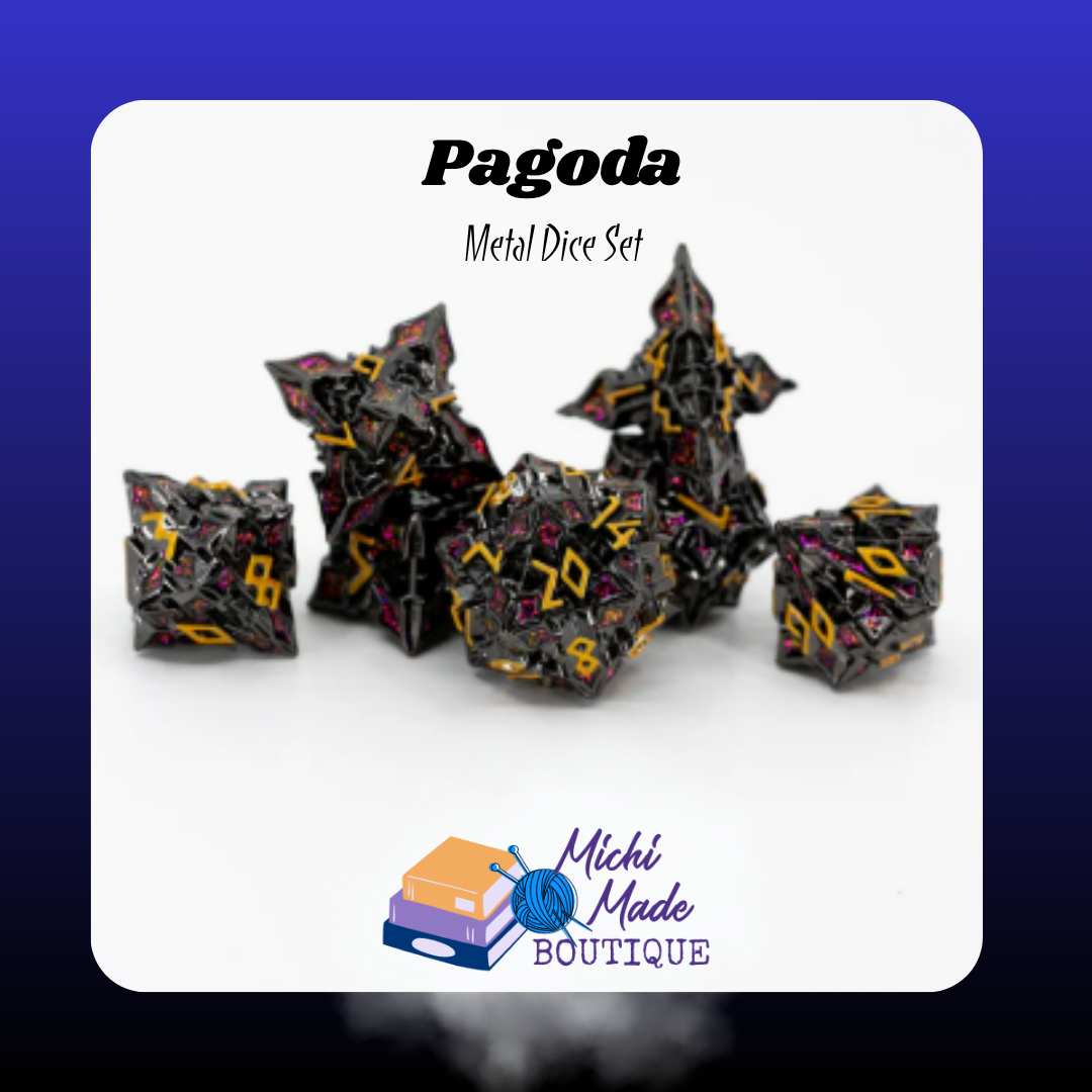 Pagoda Set Image  “Seven-piece dark metal dice set with bright gold numerals and pink enamel accents, styled with angular architectural designs on a white surface.”