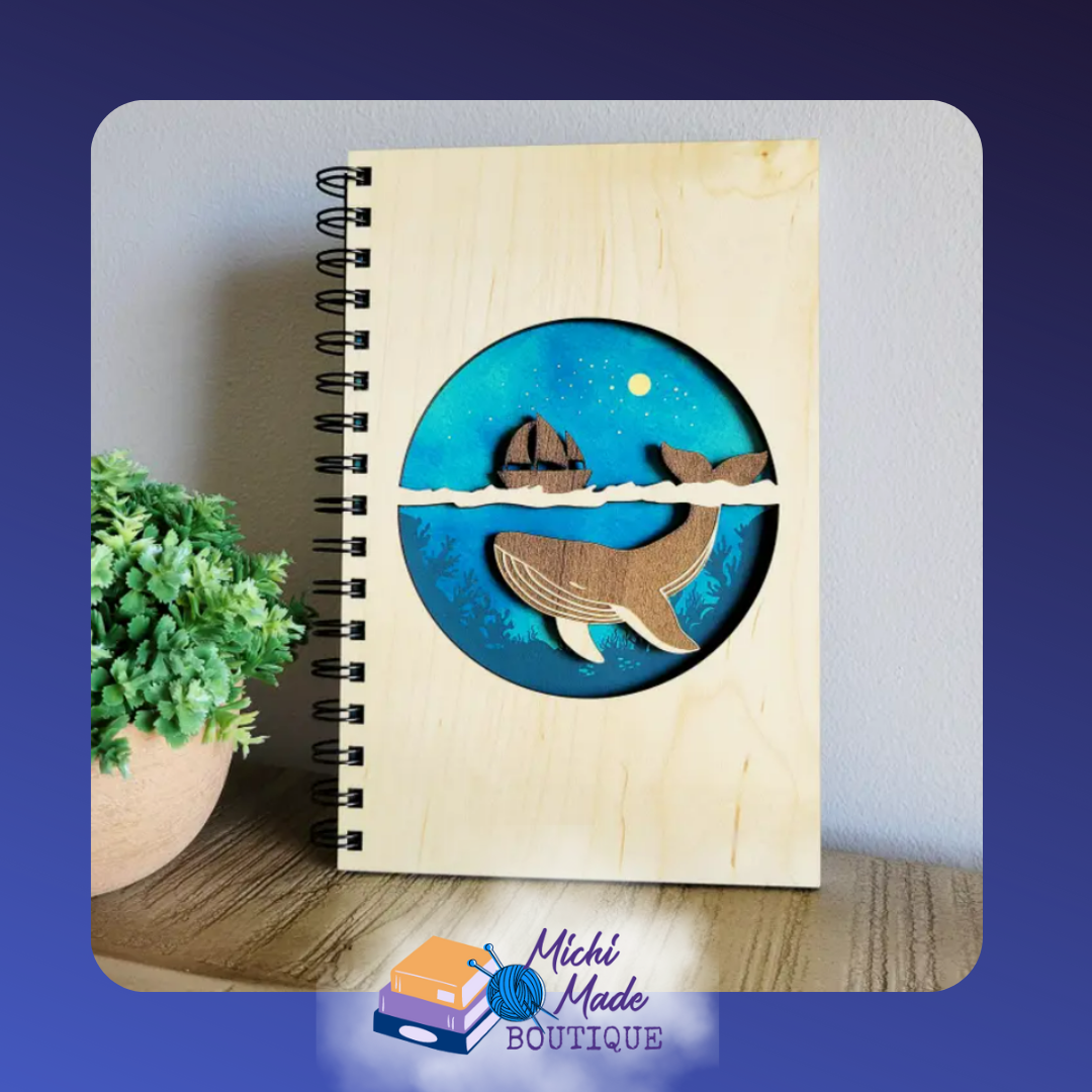 Sea Life – Wood journal with layered design of a whale under a ship, set in a deep blue ocean scene.