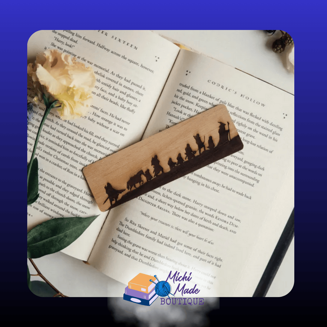 Fellowship — “Two-tone wood bookmark with the silhouette of the Fellowship traveling in a line.”