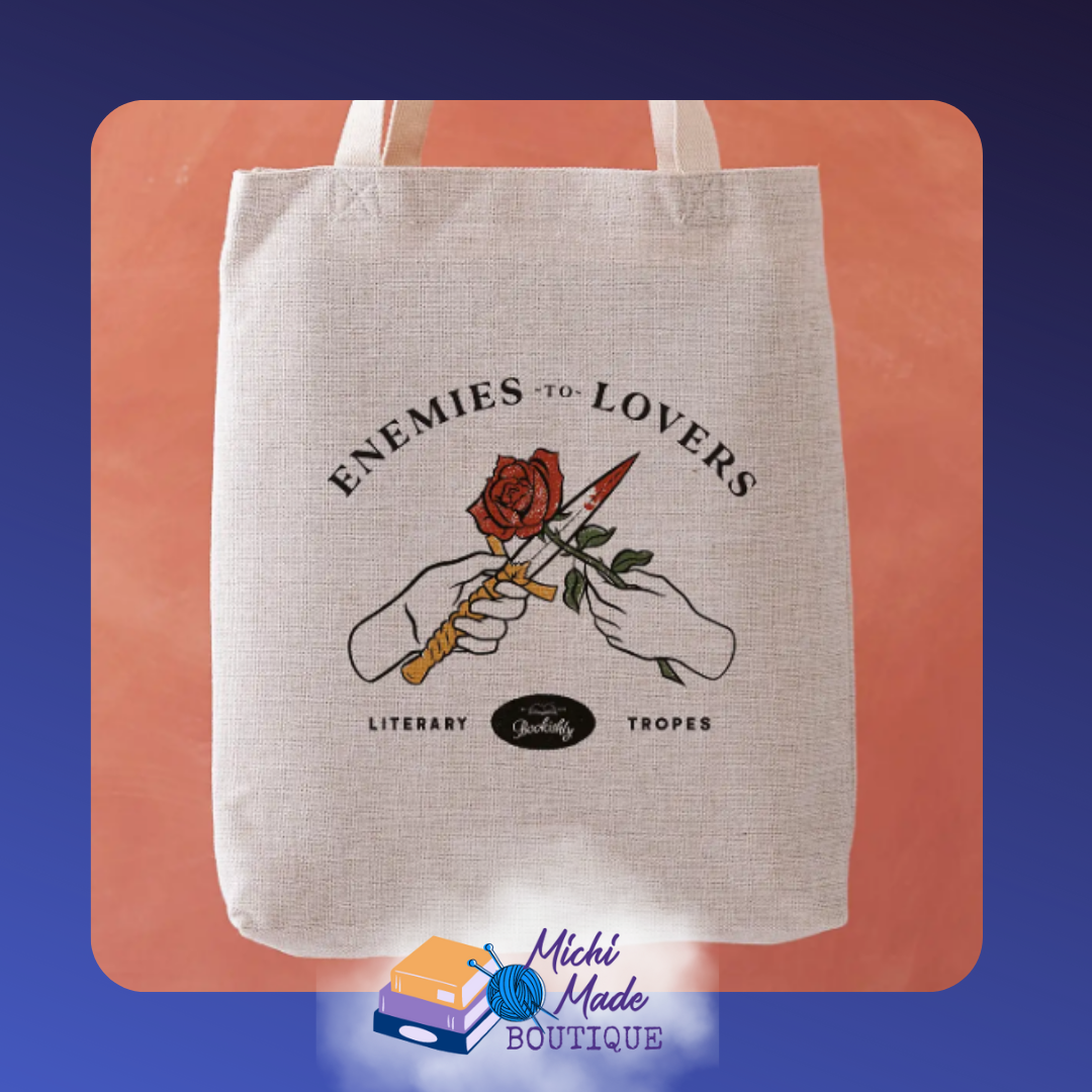 Canvas tote emblazoned with the trope “Enemies to Lovers” in bold lettering.