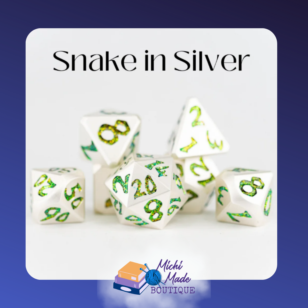 “Snake in Silver metal dice set with large shimmering green numbers on polished white metal.”
