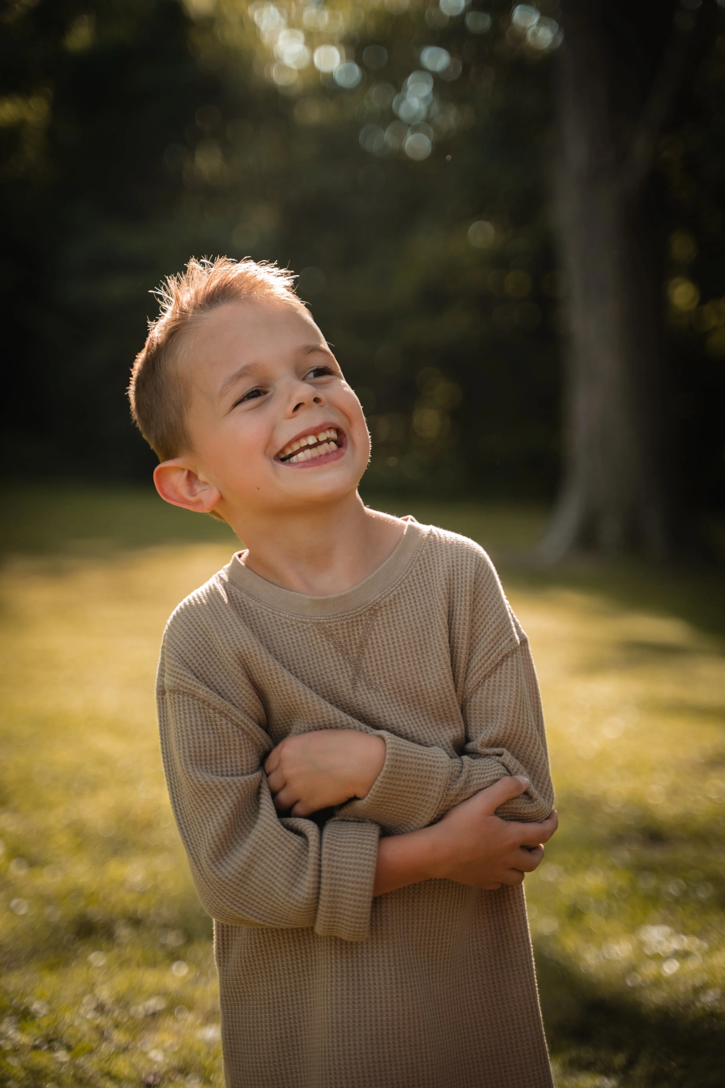 Laughing boy in a waffle-knit sweater