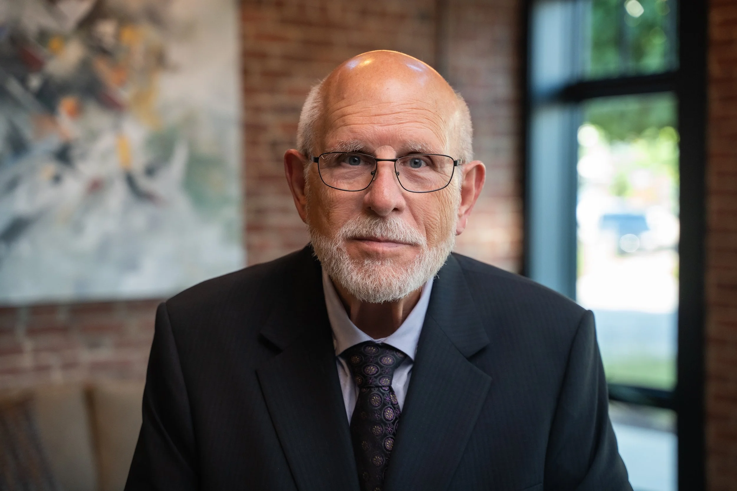 Executive headshot of a man in a suit