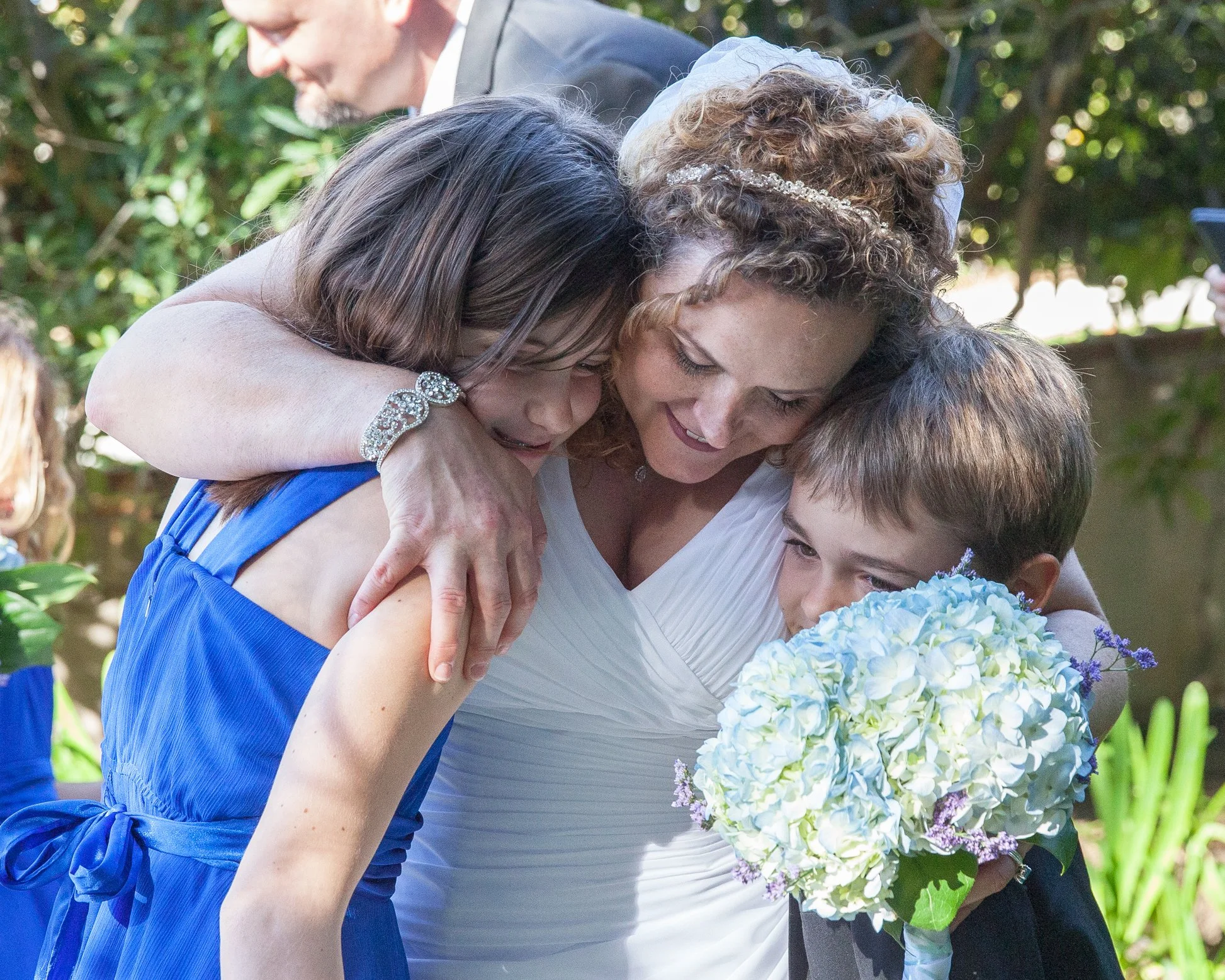 older-bride-hugging-stepchildren-after-ceremony-Santa-Barbara.jpg