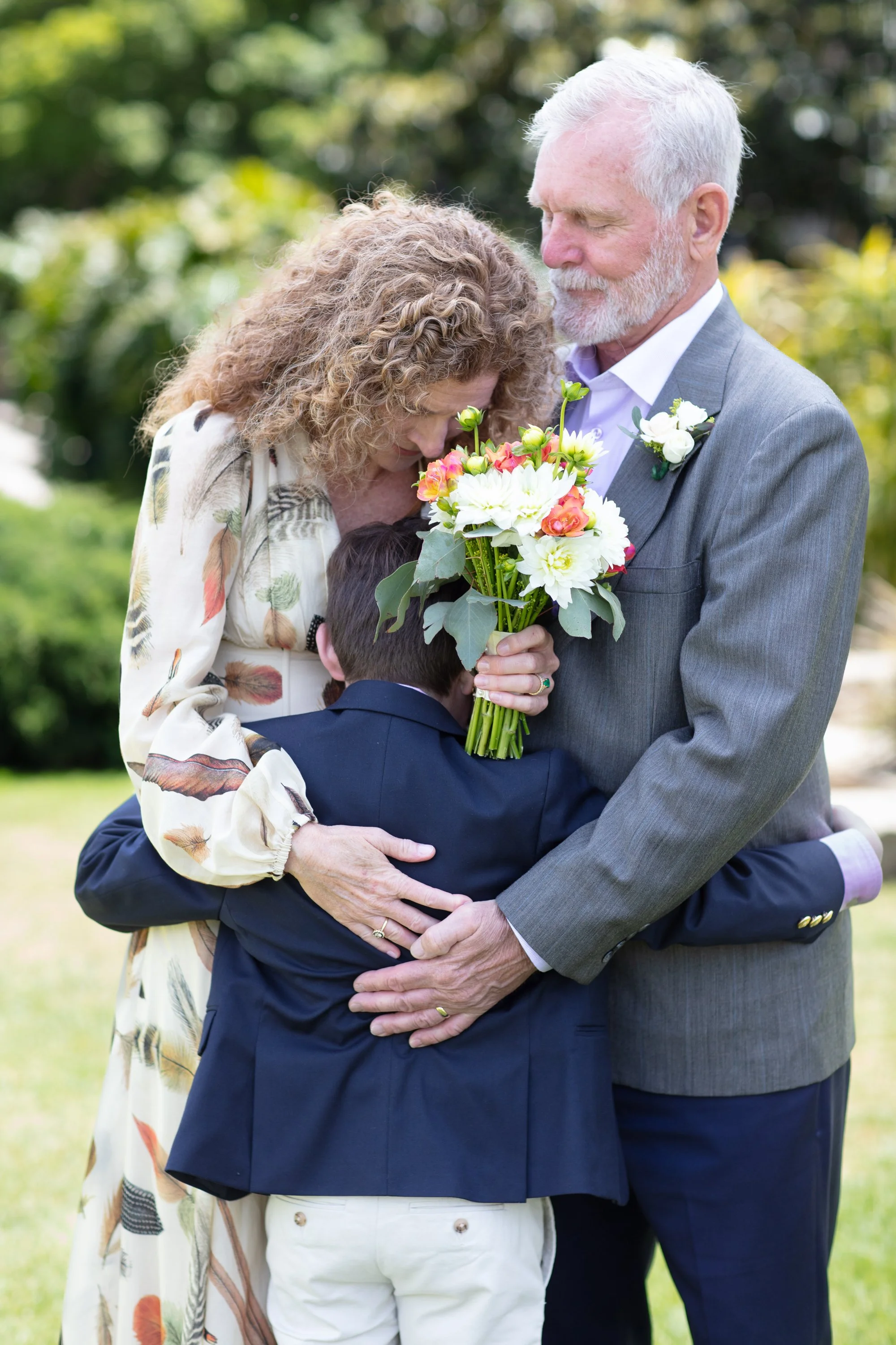 older-couple-wedding-Santa-Barbara-group-hug-son.jpg