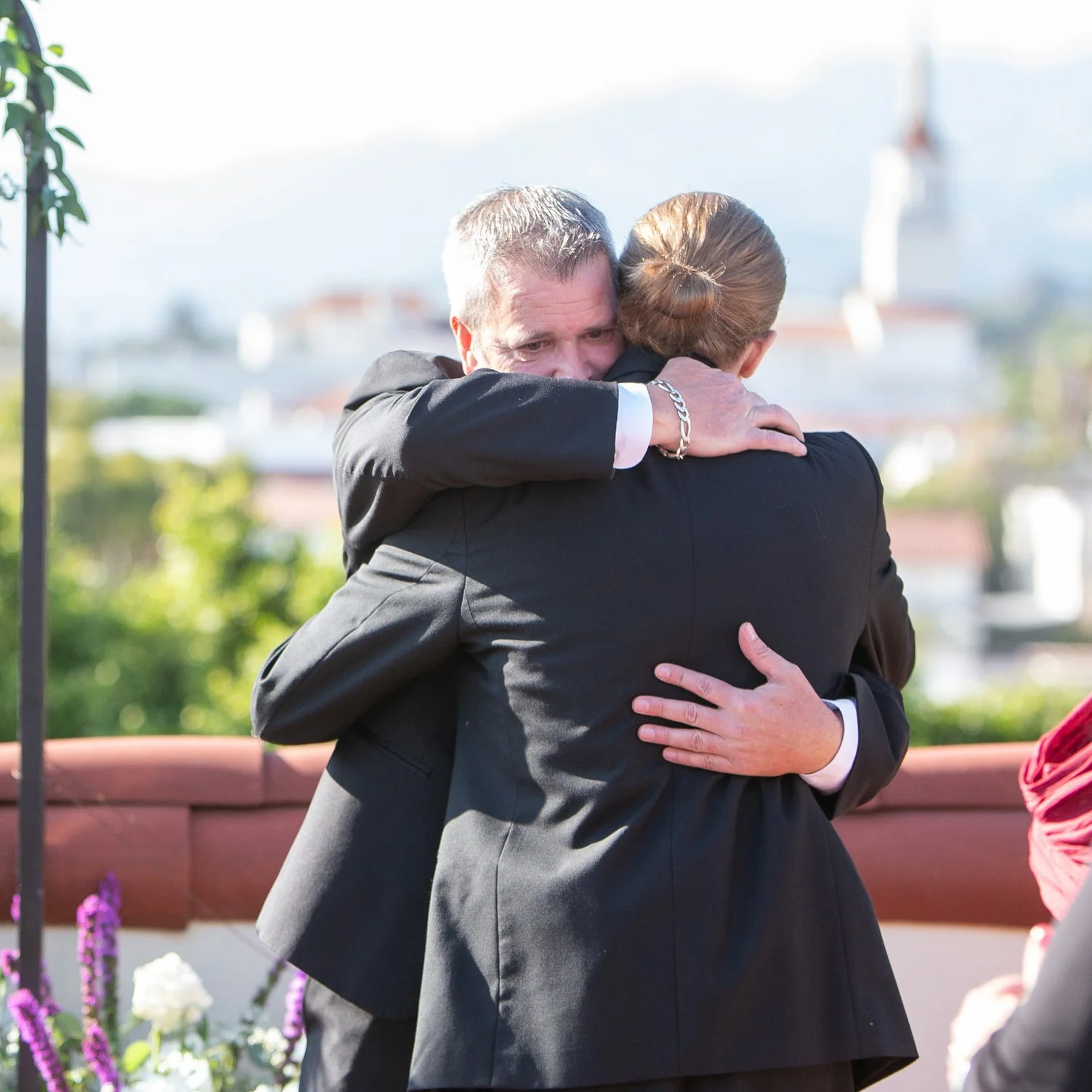older-groom-hugging-stepson-Santa-Barbara-best-man.jpg