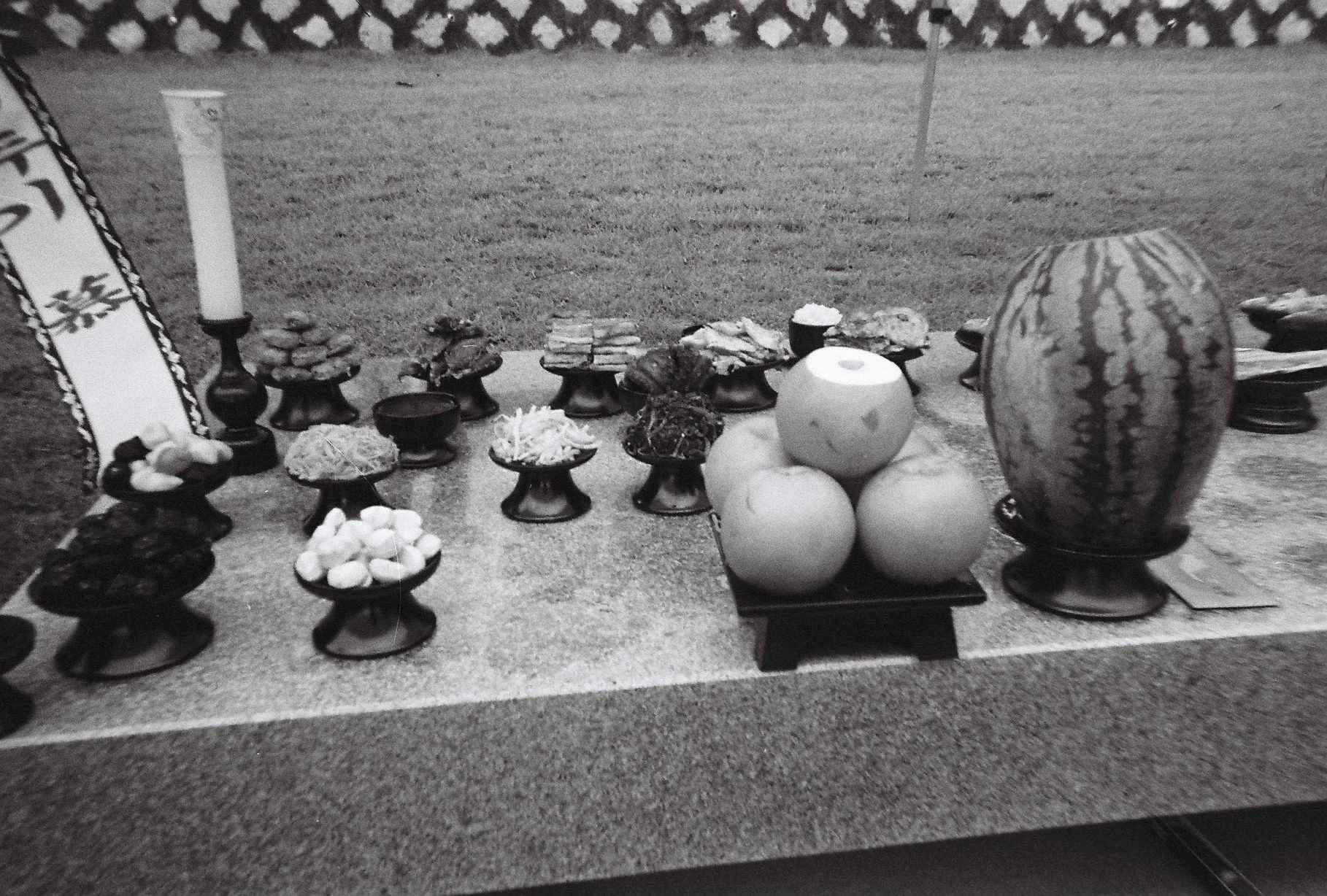 An outdoor table containing a variety of fruit, fish and candy laid as a ritual offering to ancestors during a traditional ceremony in Pilbong village, South Korea.