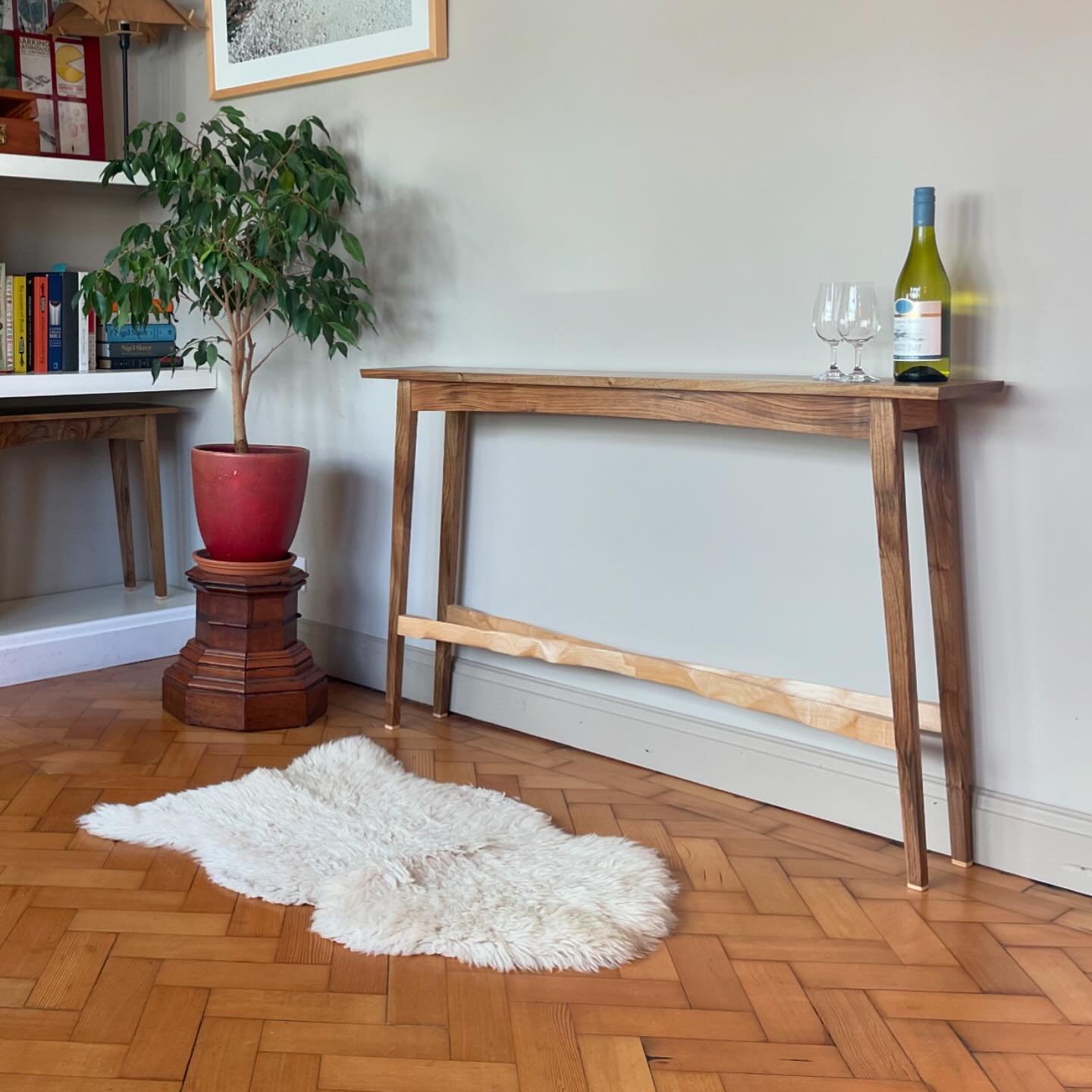 English Walnut Console Table. Modernist design celebrating a unique board of Oxfordshire English Walnut, and a sculptural cross-brace made from bright Maple.