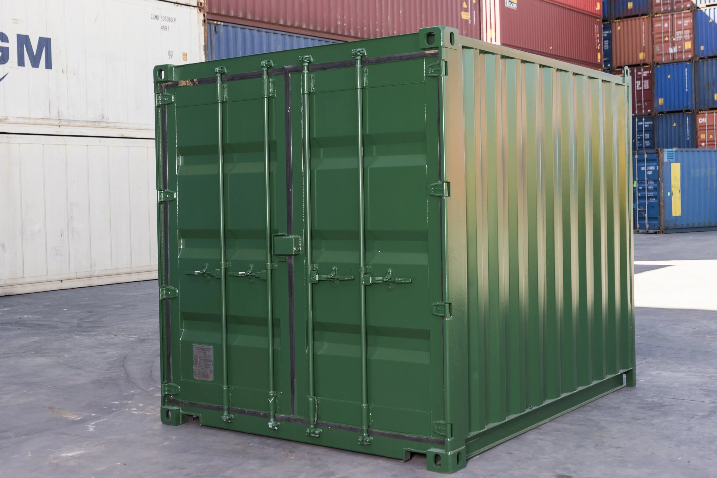 10ft shipping container painted green with original cargo doors closed