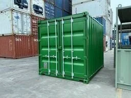 a 10ft Green shipping container in an industrial storage yard with other containers around.