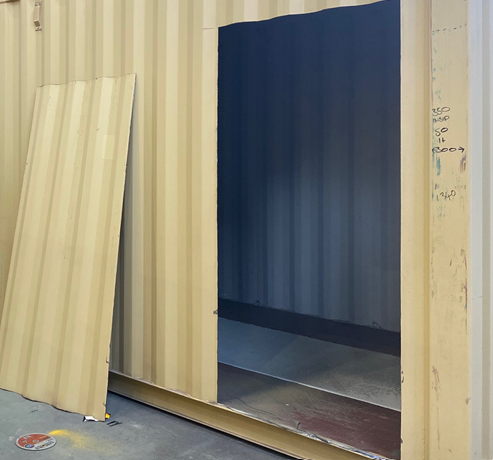 Shipping container with cut out for door ready for frames