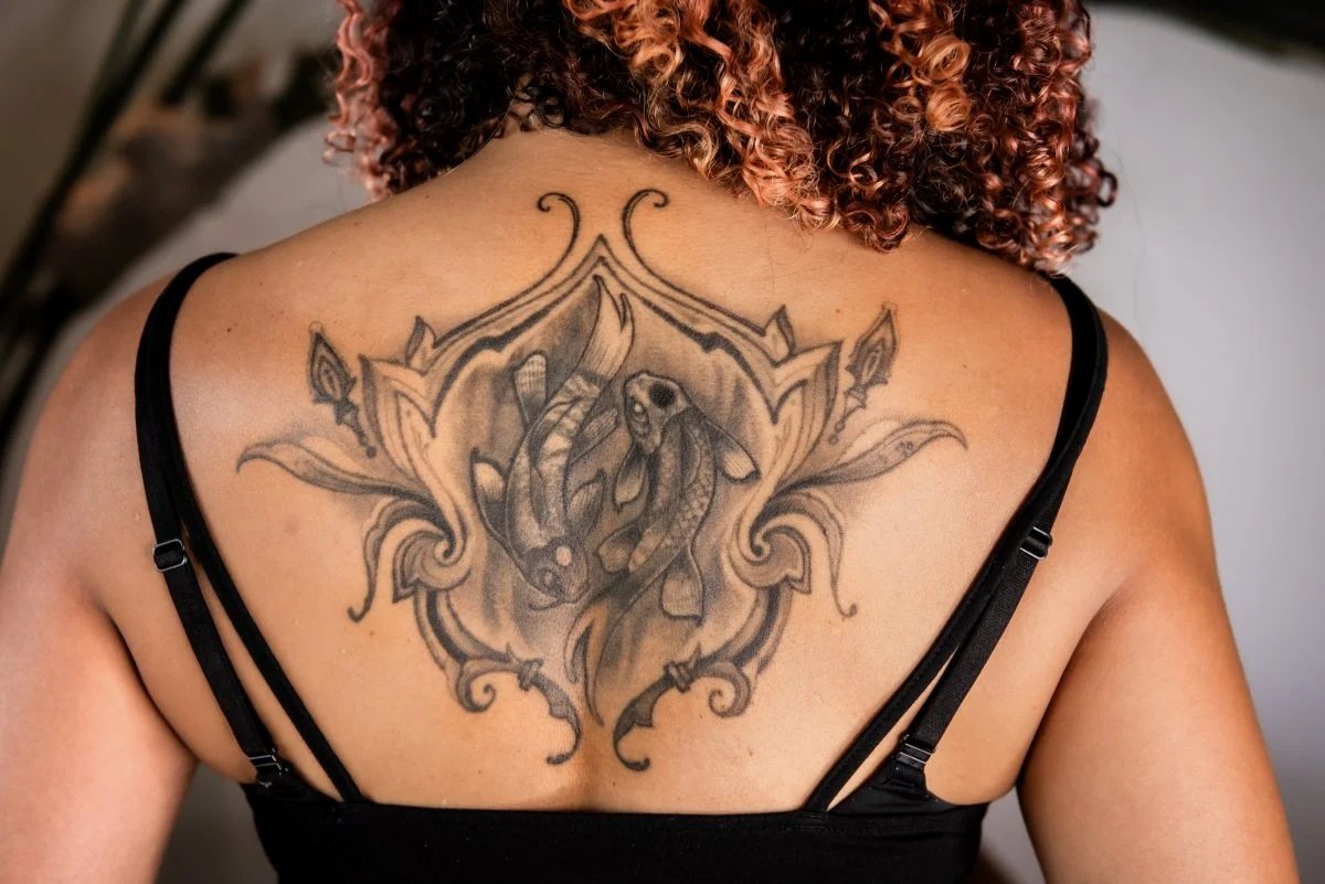 Back tattoo on melanated skin 