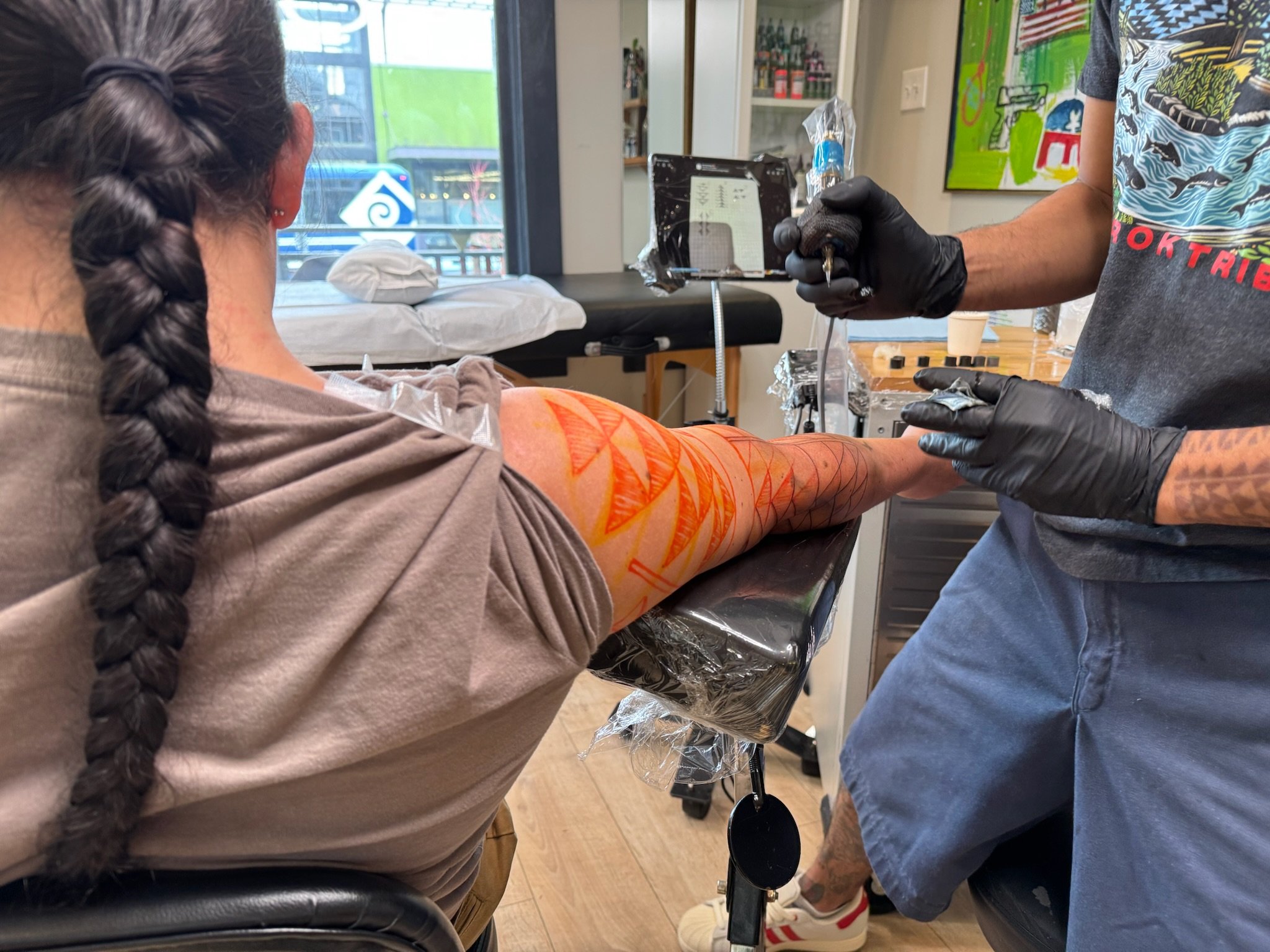 Tattoo artist Toby BIPOC tattoo artist draws on a concept for a Native tattoo client in SE Portland