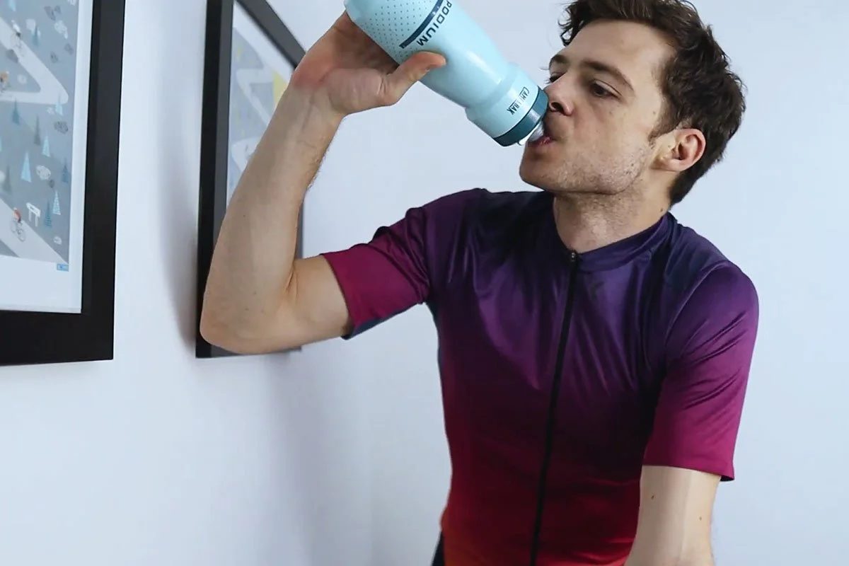 James is drinking water while training on the turbo trainer