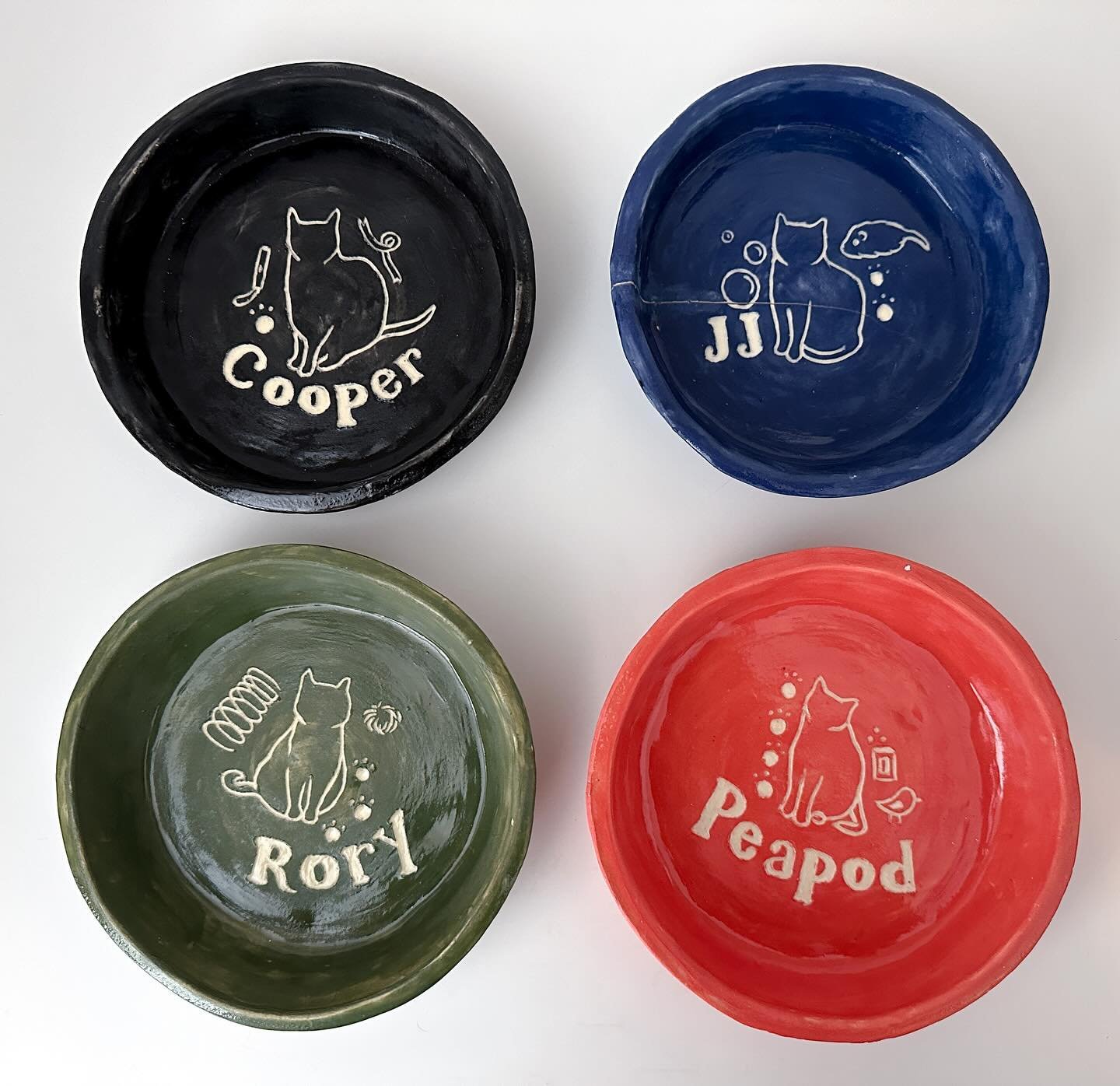 Some ceramic things I made while working at GSA this summer: a set of coasters and&mdash;my favorite&mdash;a bowl for each of my cats. Everything was hand-built and I used colored slip and sgraffito to create the designs. It&rsquo;s been a while sinc