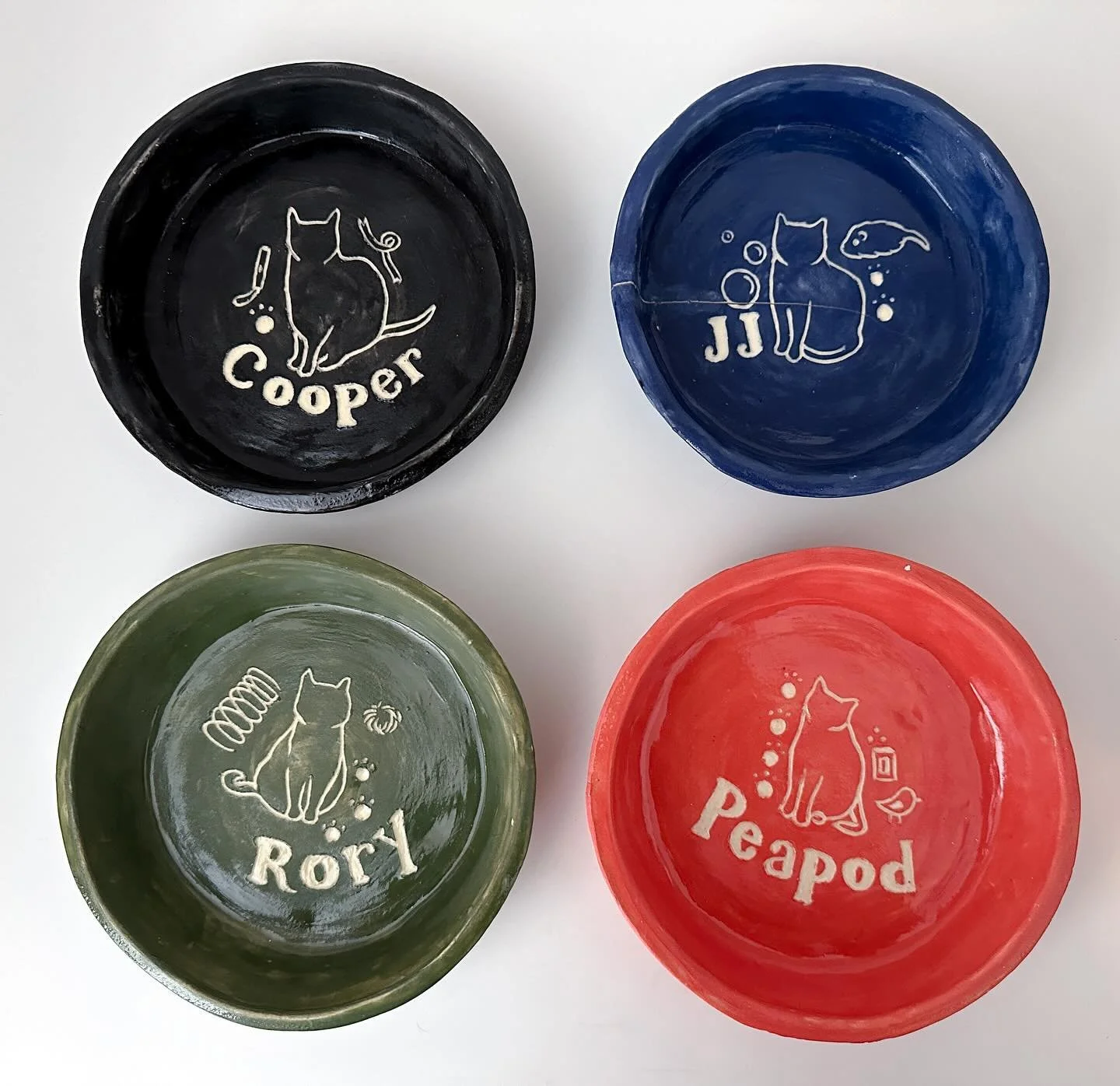 Some ceramic things I made while working at GSA this summer: a set of coasters and&mdash;my favorite&mdash;a bowl for each of my cats. Everything was hand-built and I used colored slip and sgraffito to create the designs. It&rsquo;s been a while sinc