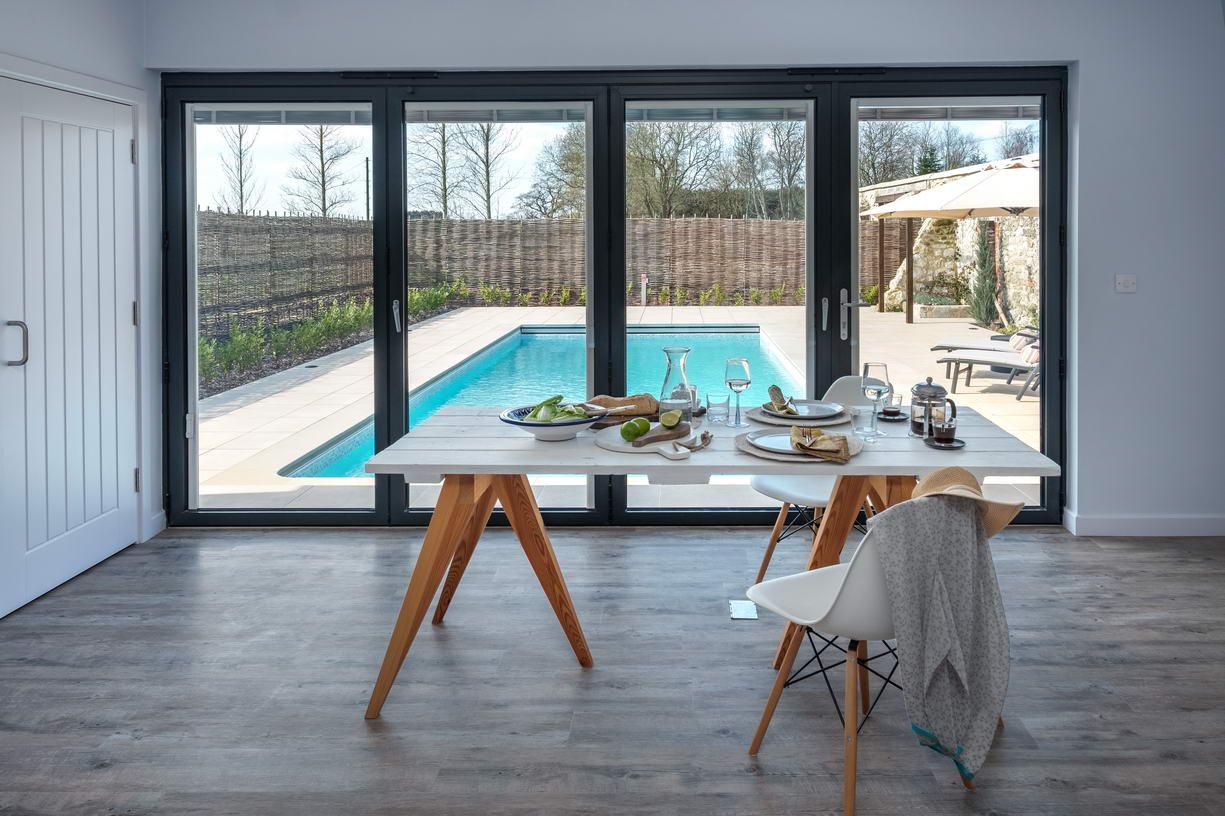 Interior design of the contemporary pool house at Wacklands Farmhouse on the Isle of Wight, creating a practical and refined leisure space that complements the wider farmhouse refurbishment.
