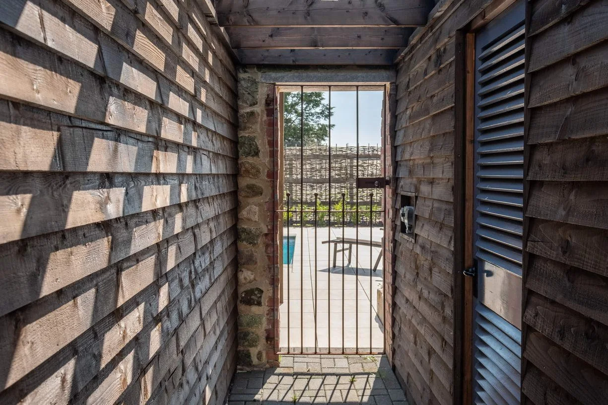 Architectural details of the Wacklands Farmhouse pool house, illustrating Mattinson Associates' approach to contemporary design within the context of a historic rural estate with adjacent listed buildings.
