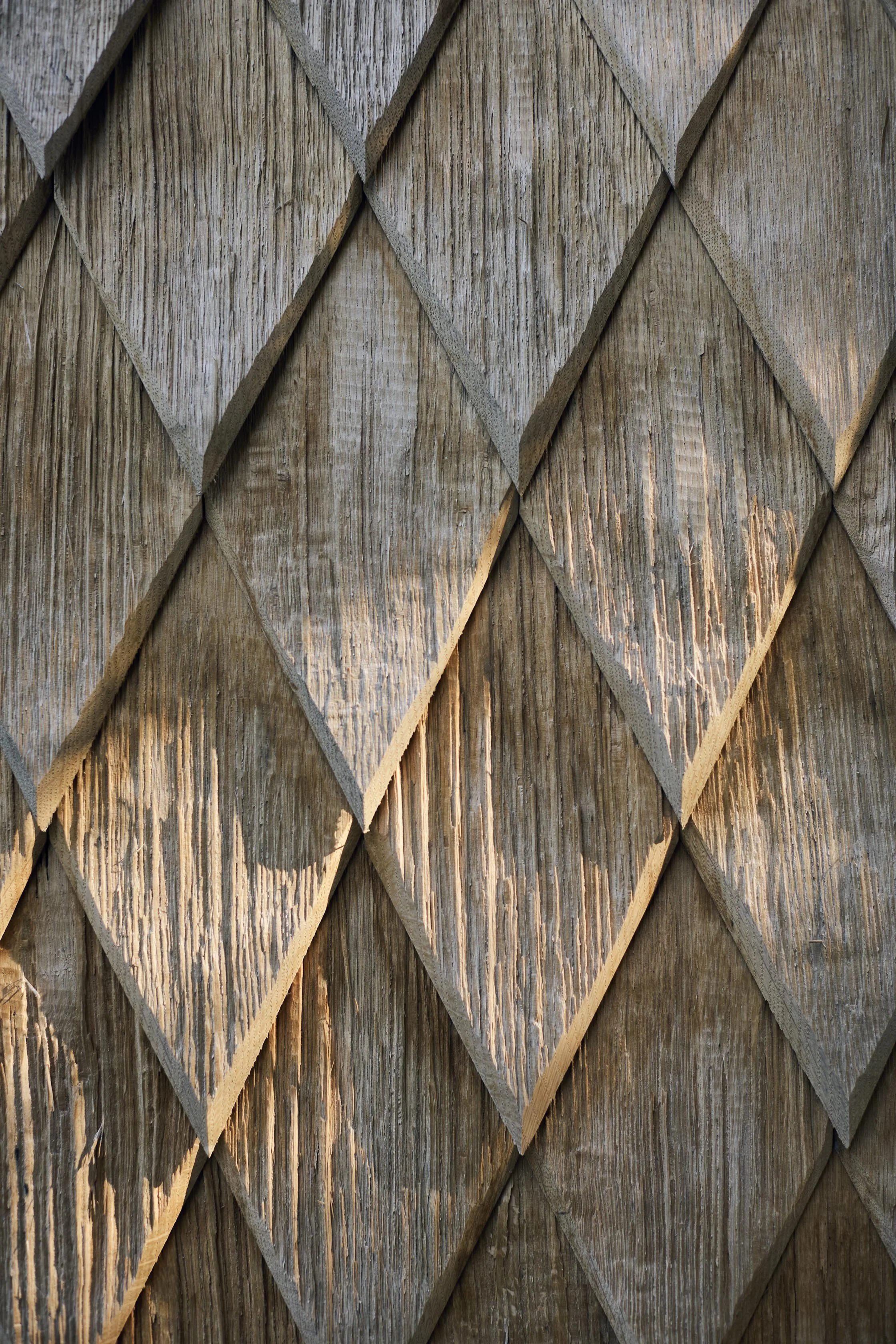 Oak diamond shingles on bespoke architectural extension to coastal home
