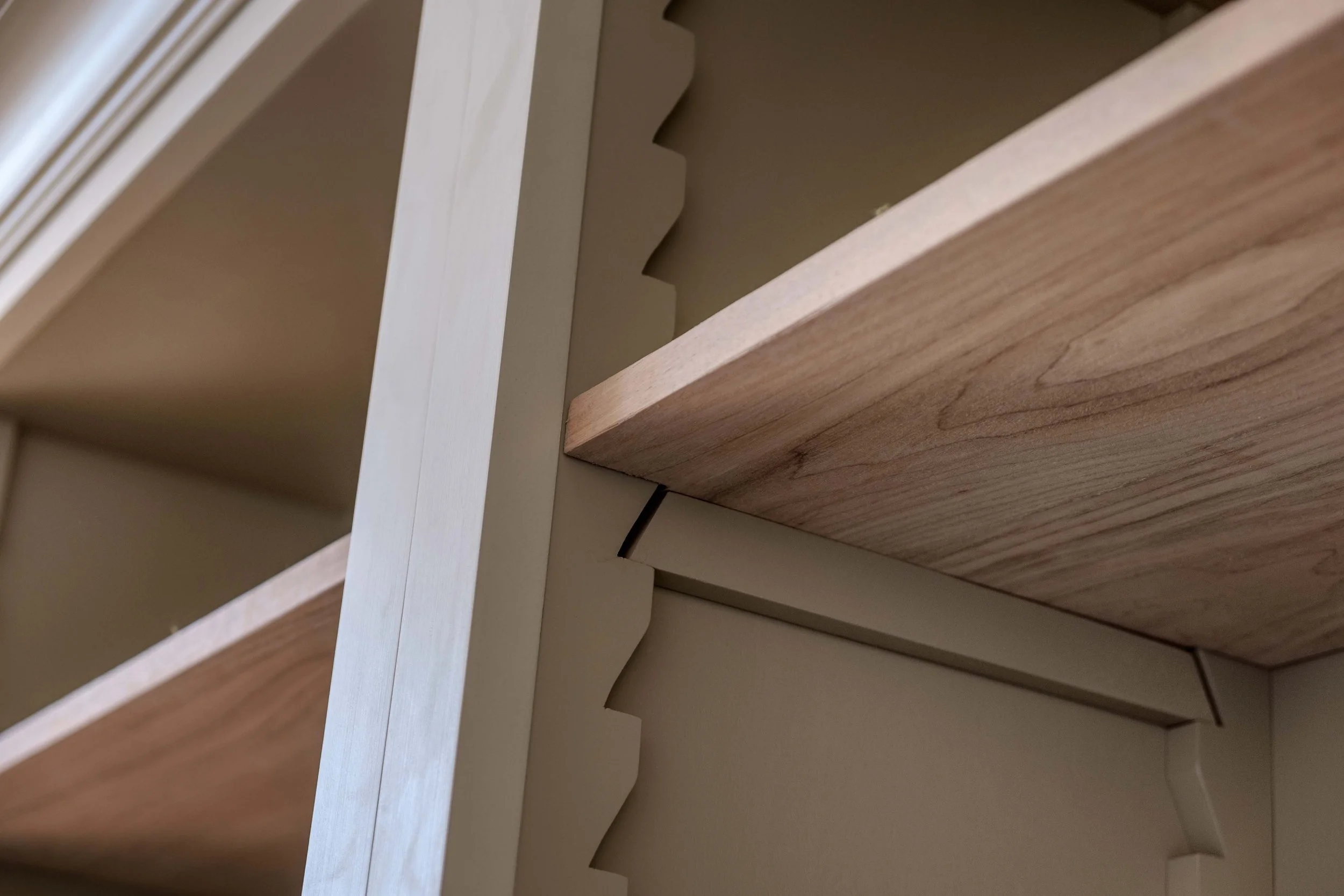 Close-up of bespoke timber joinery at Barton Manor Estate, highlighting the natural wood grain and carefully detailed shelving.