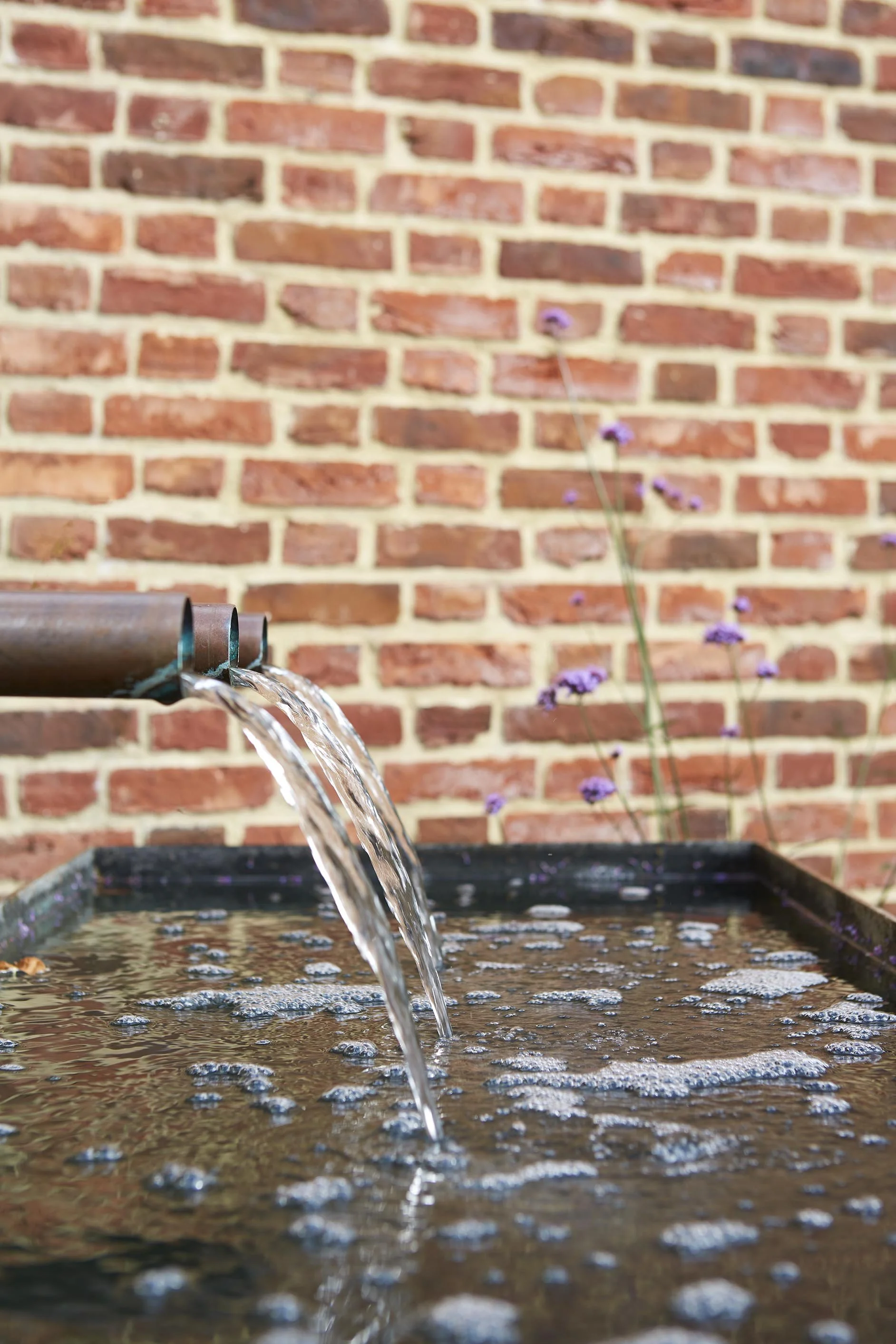 bespoke tranquil water feature in walled garden of listed farmhouse building