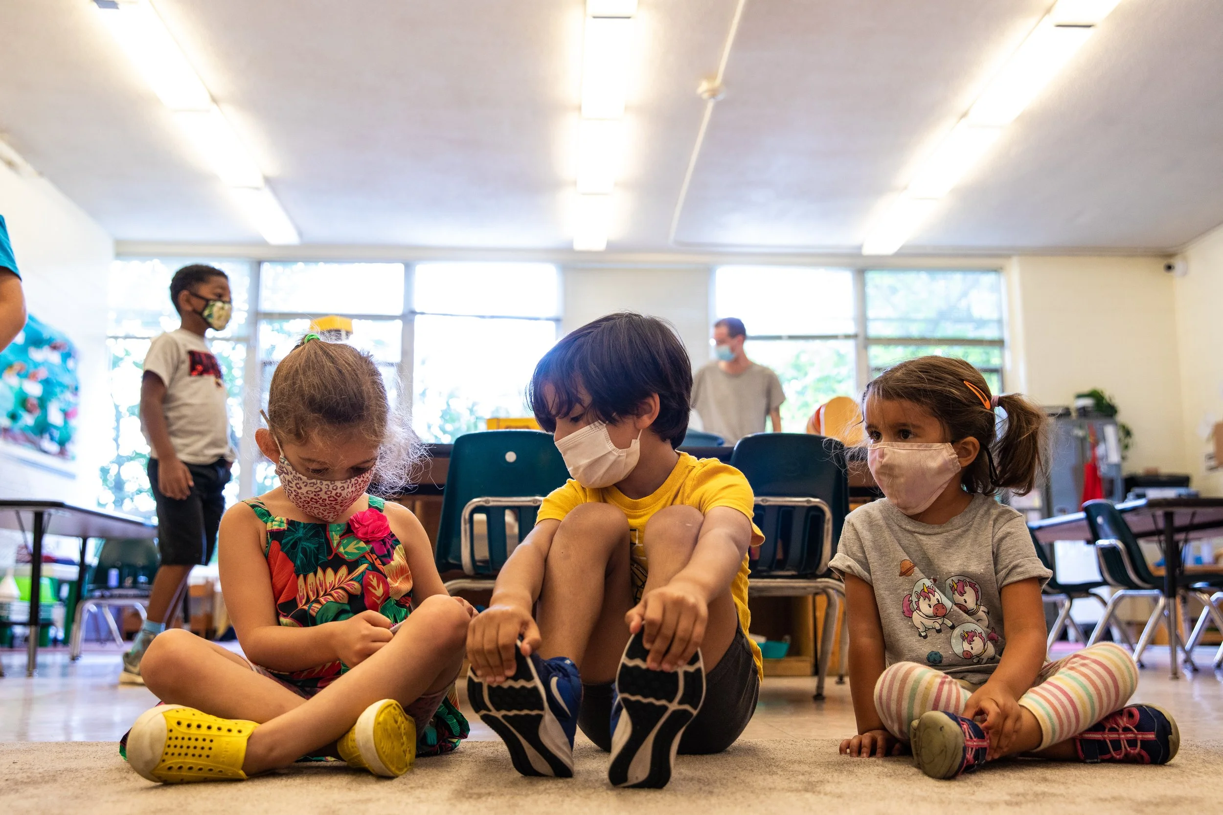 three students sitting on the floor at Brown Fox Point.jpg