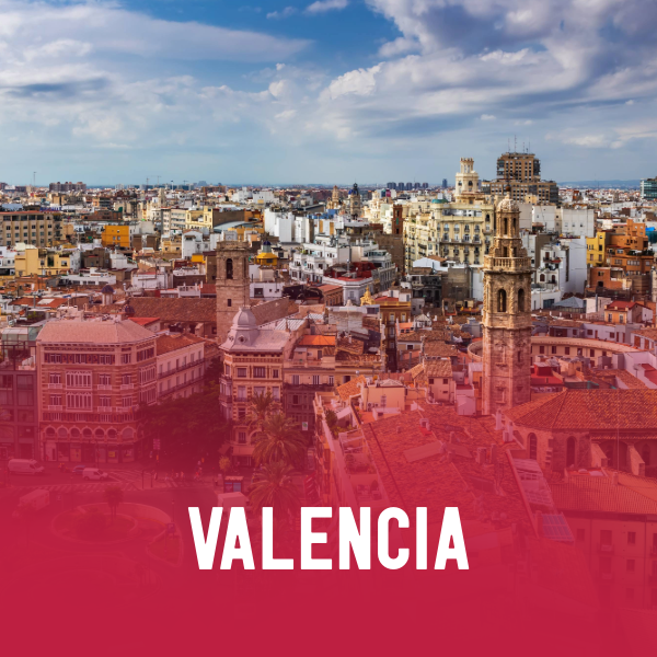 A panoramic view of Valencia, Spain, with historic buildings, a clock tower, and a partly cloudy sky, overlaid with the text "Valencia 2026" in bold white letters on a pink background.