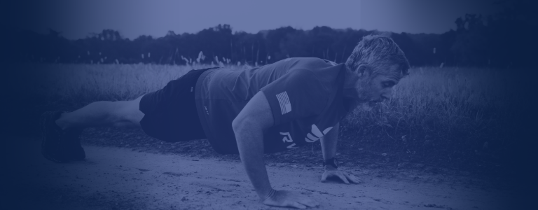 A male doing pushups outside