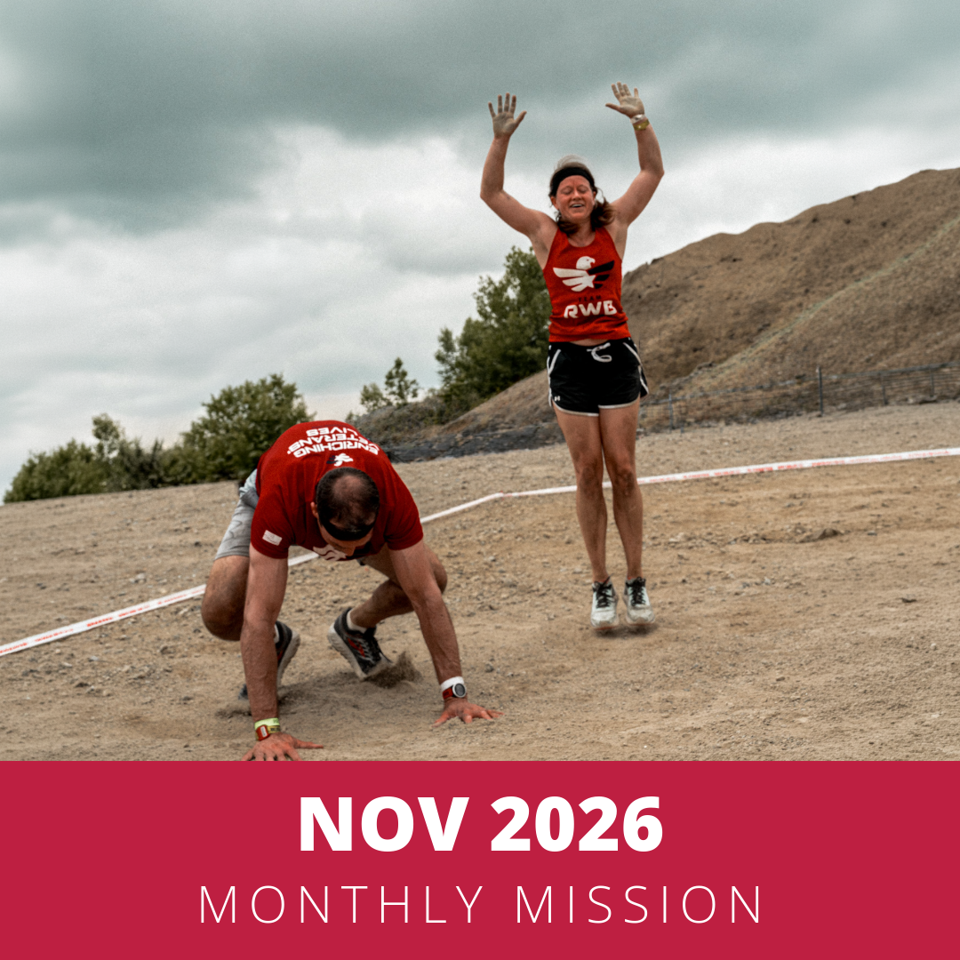 A man wearing a red athletic shirt and black shorts is doing a squat exercise with a dumbbell at a gym. The background includes gym equipment and a wooden wall. The bottom of the image has a maroon band with white text reading "NOV 2026 MONTHLY MISSION."