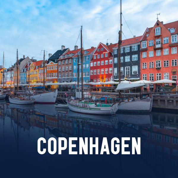 View of colorful buildings along a harbor with sailboats docked and the text 'Copenhagen' in bold white letters at the bottom.