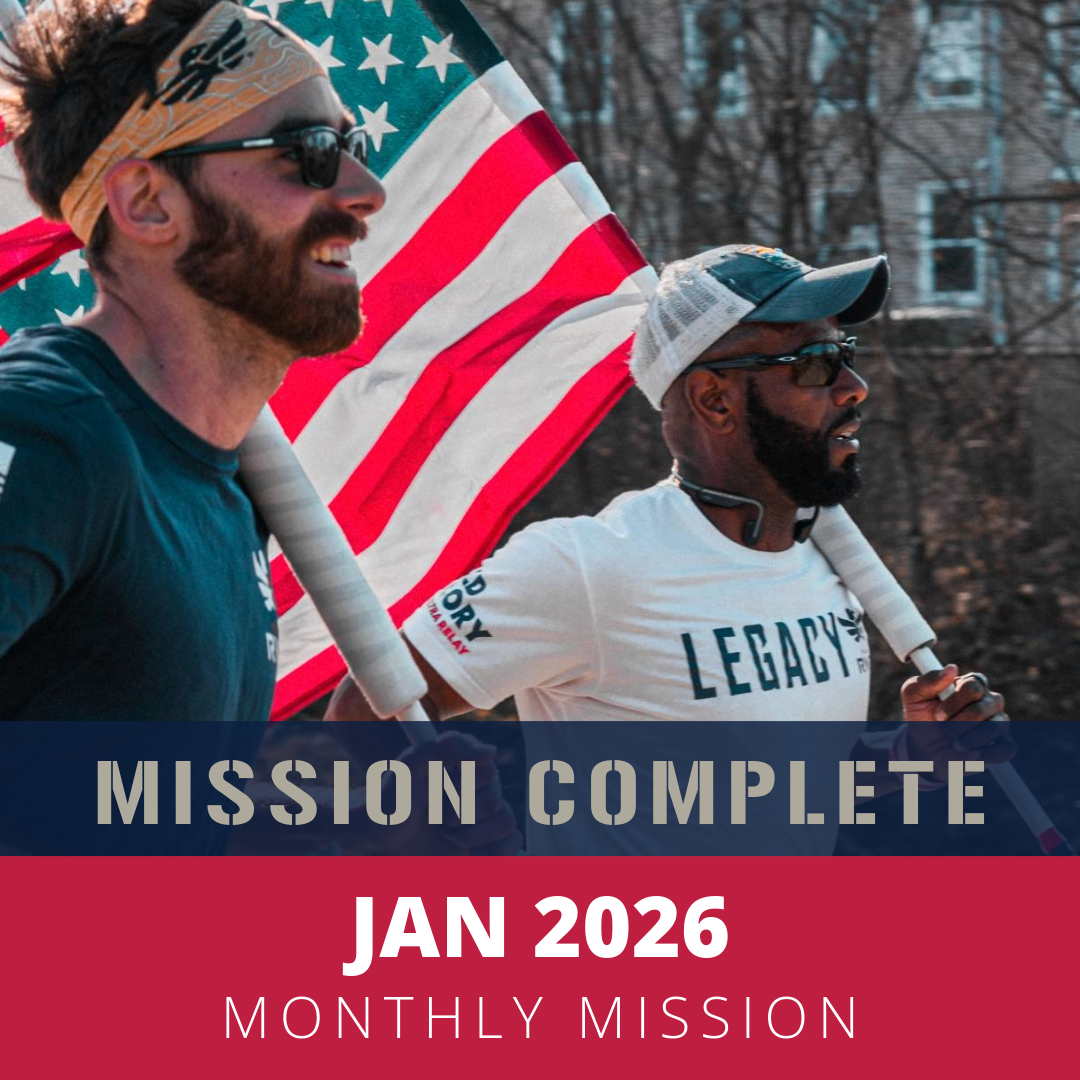 Two men running outdoors during a sunny day, one holding an American flag, with a logo on their shirts indicating participation in a race or event, and a cityscape in the background. The text overlay reads 'JAN 2026 MONTHLY MISSION'.
