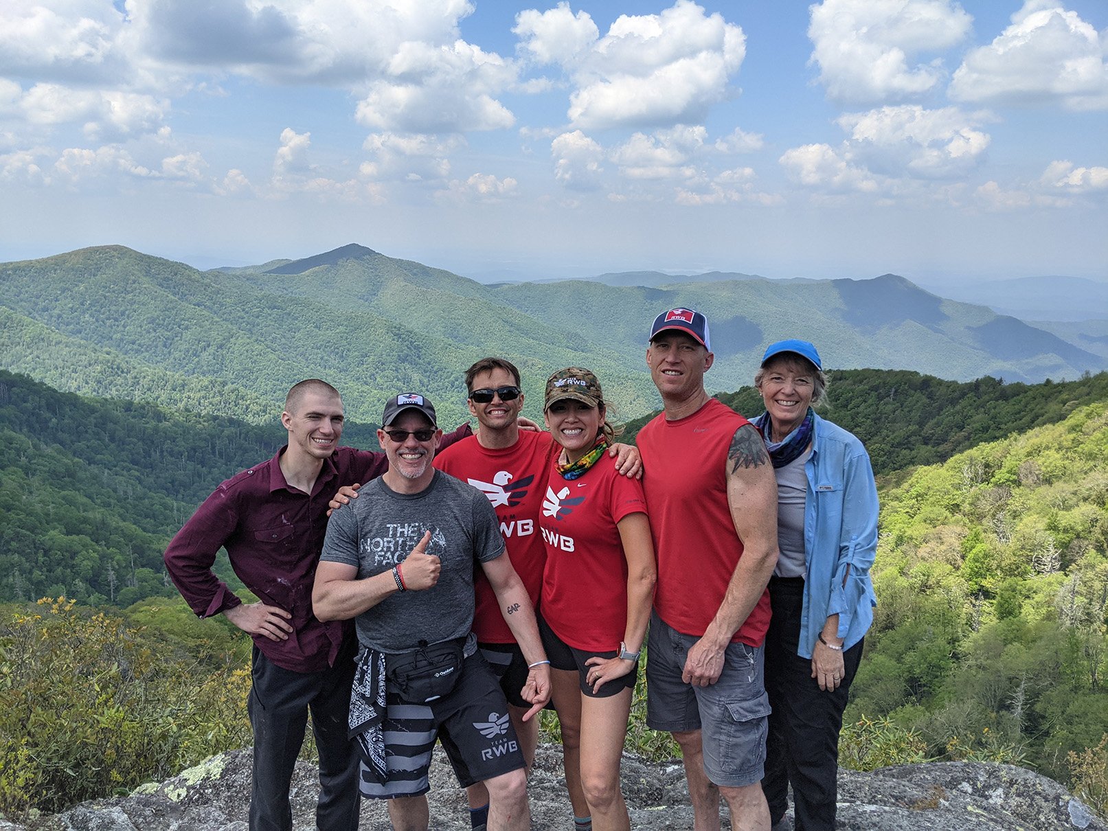 Hikers posing at top of mountain for picture