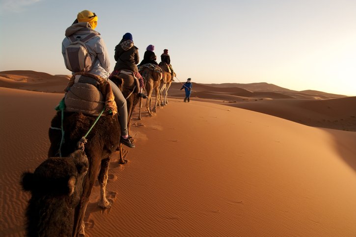 Tourists-on-train-of-camels-in-Sahara-led-by-guide-155157473_726x482.jpeg