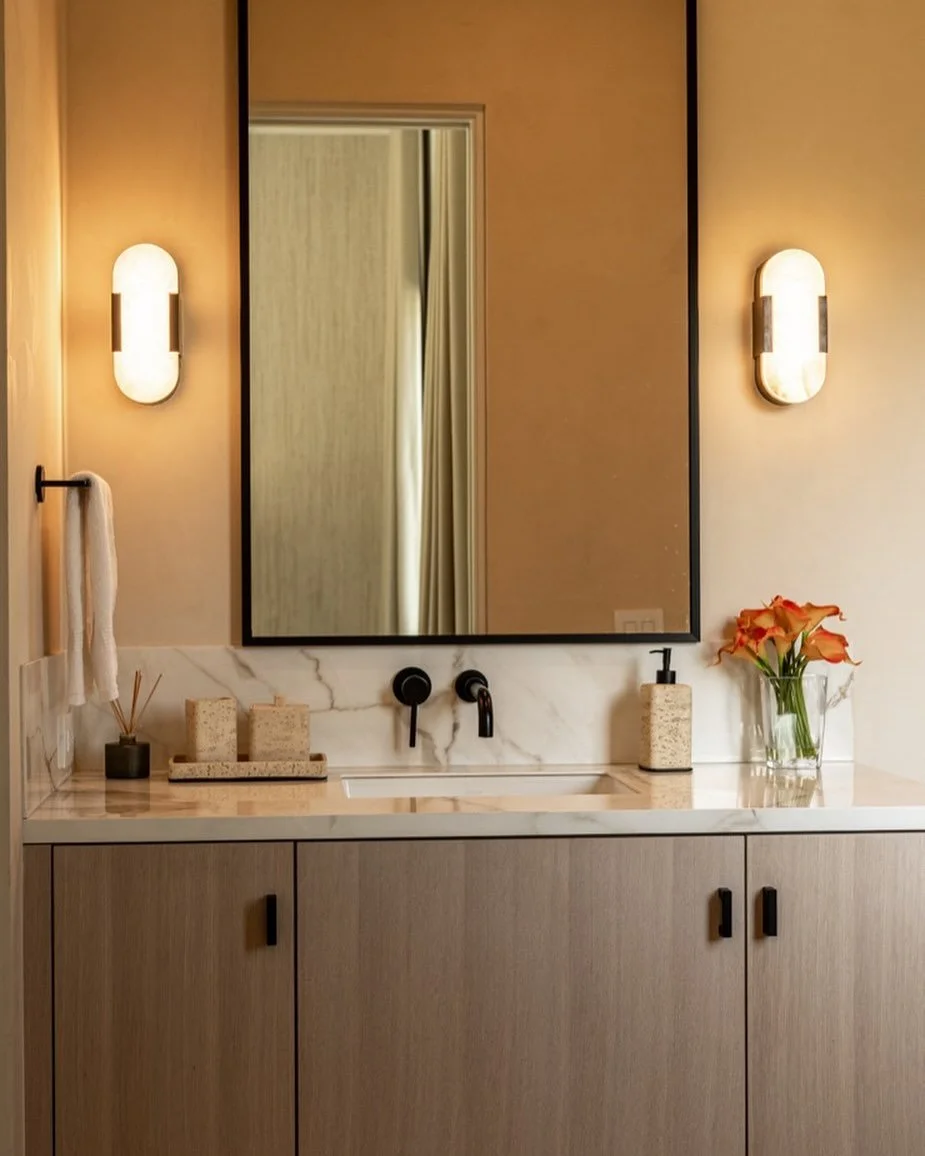 ✨ Balanced &amp; Beautiful ✨

There&rsquo;s something incredibly soothing about symmetry &mdash; especially in a bathroom where calm and order set the tone. Here, the mirror, sconces, and faucet create a perfectly balanced focal point that draws your
