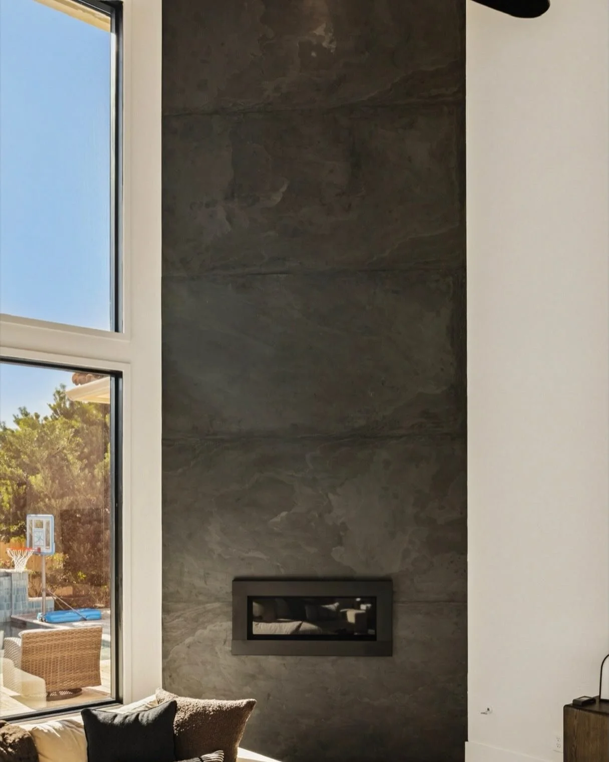 There&rsquo;s something about a double-story fireplace that just owns the room&hellip; and this one understood the assignment. 🔥

This stunning feature is clad in Air Slate from Porcelanosa&mdash;a sleek, ultra-thin material designed for wall applic