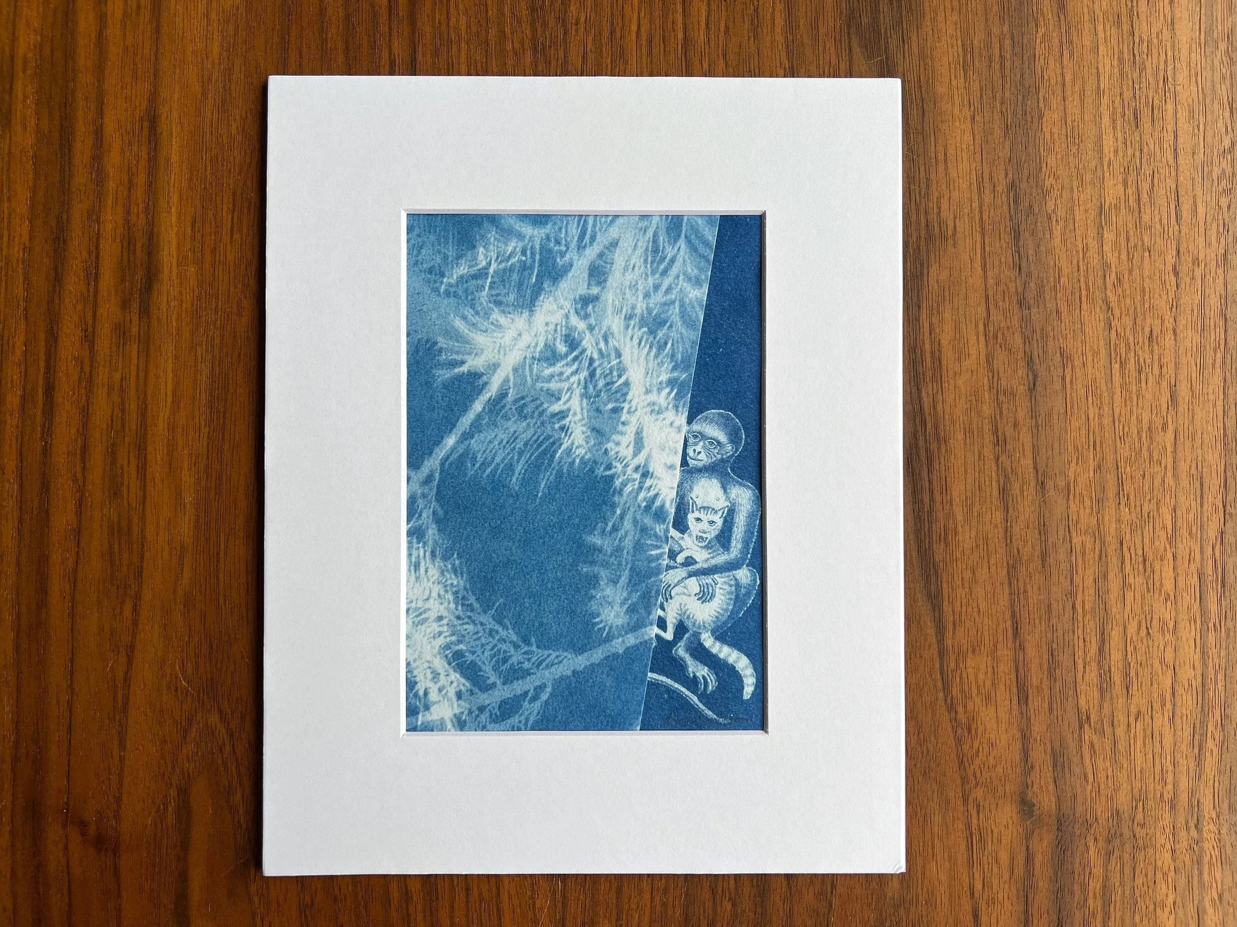 Original collage made of two cyanotypes of a monkey holding a cat and a cypress tree.
