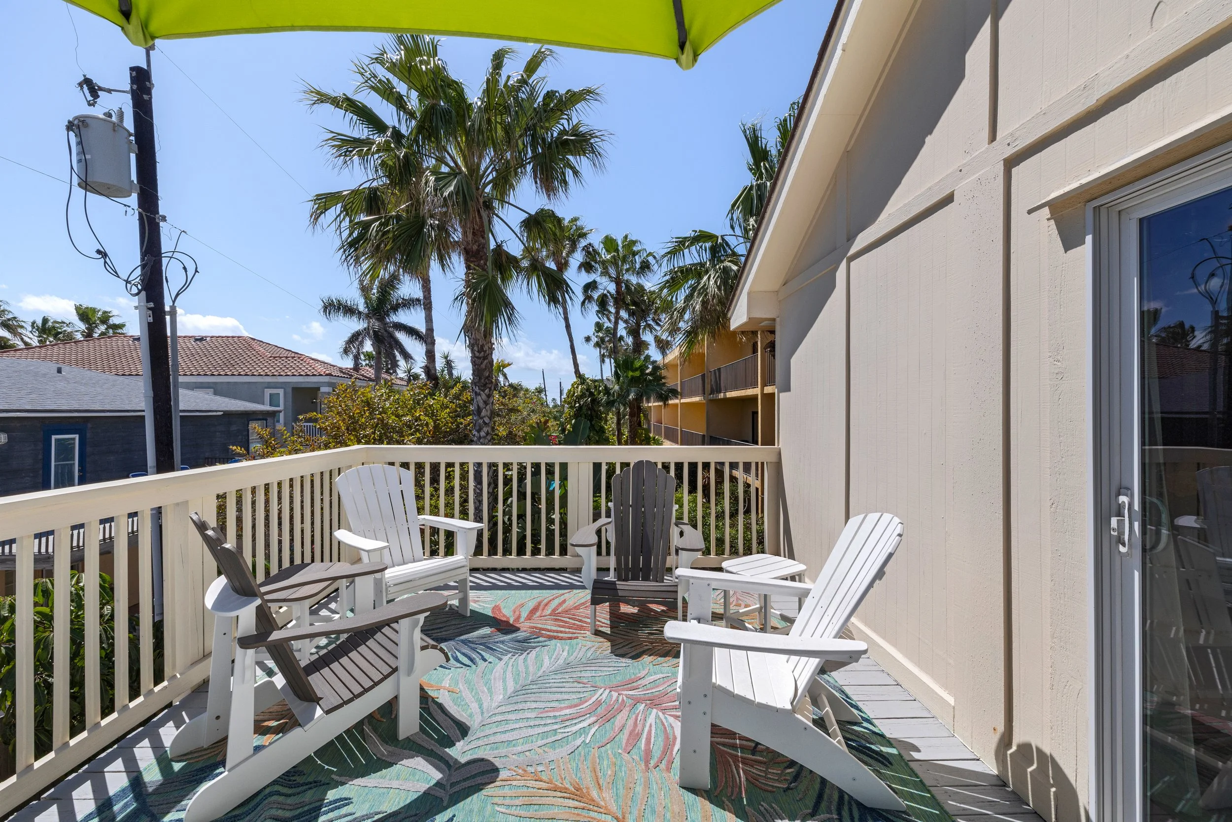 Back deck with 2 seating areas and views of the gulf