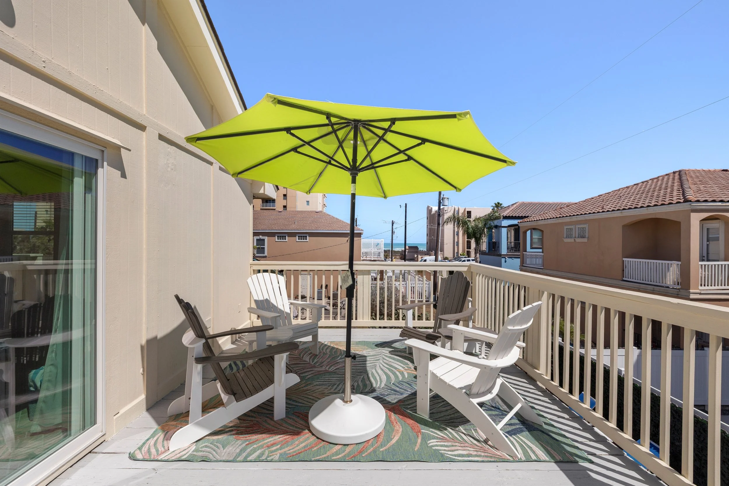 Back deck with 2 seating areas and views of the gulf