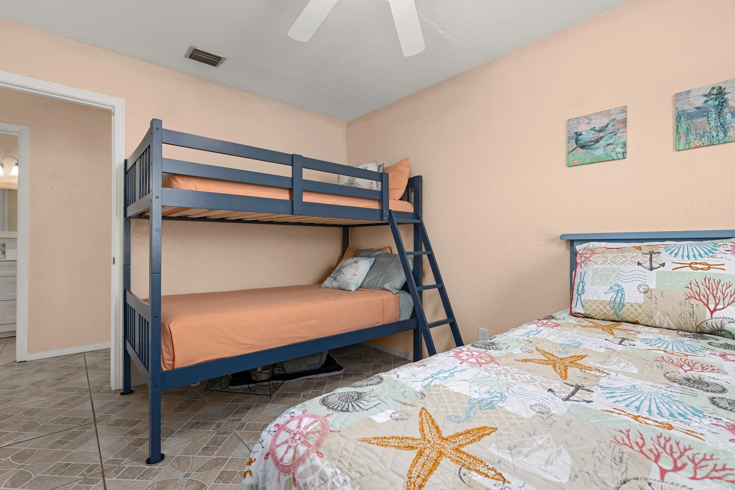 2nd bedroom twin bunk beds with a queen bed