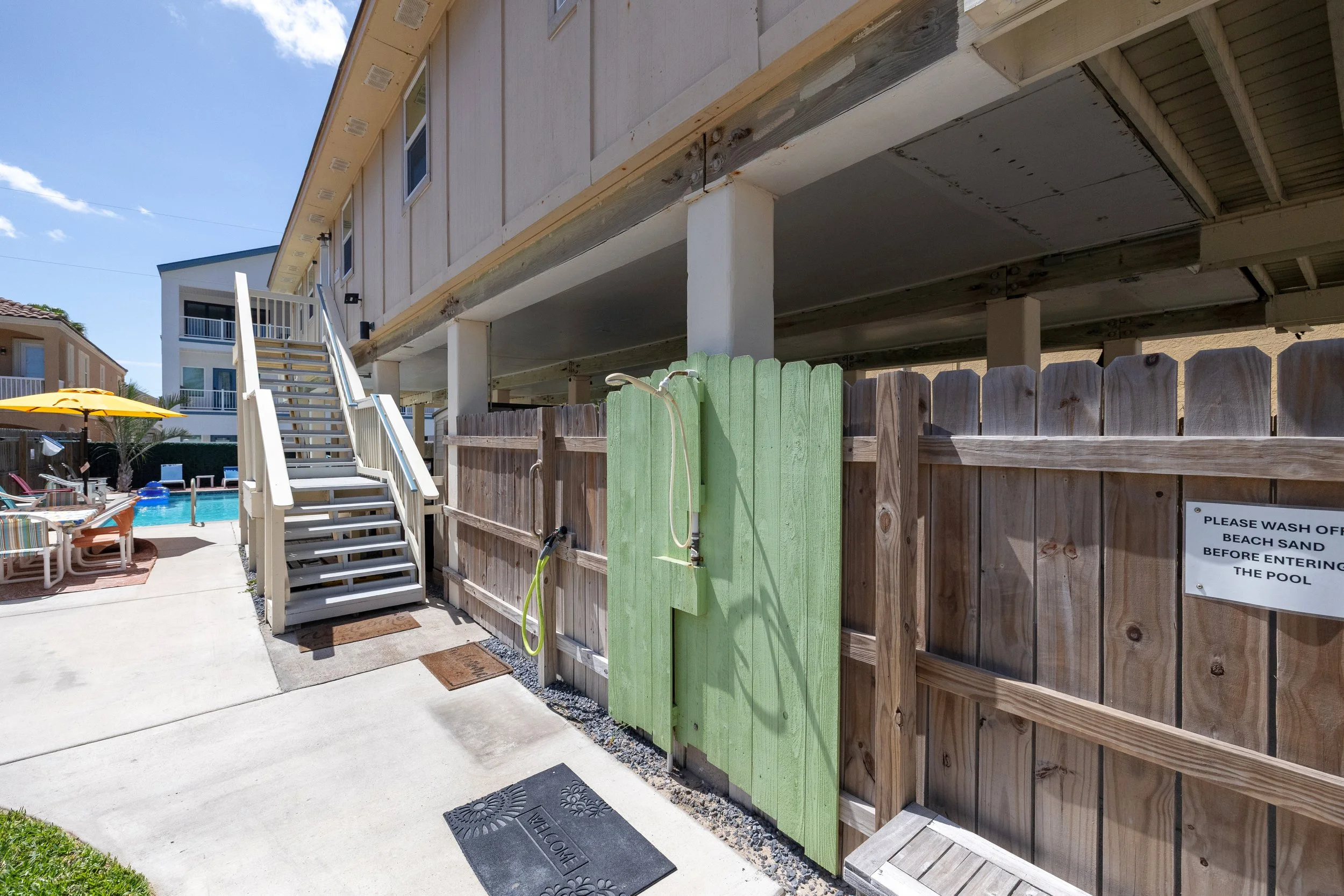 Outdoor shower to rinse sand off and stairs leading to the house