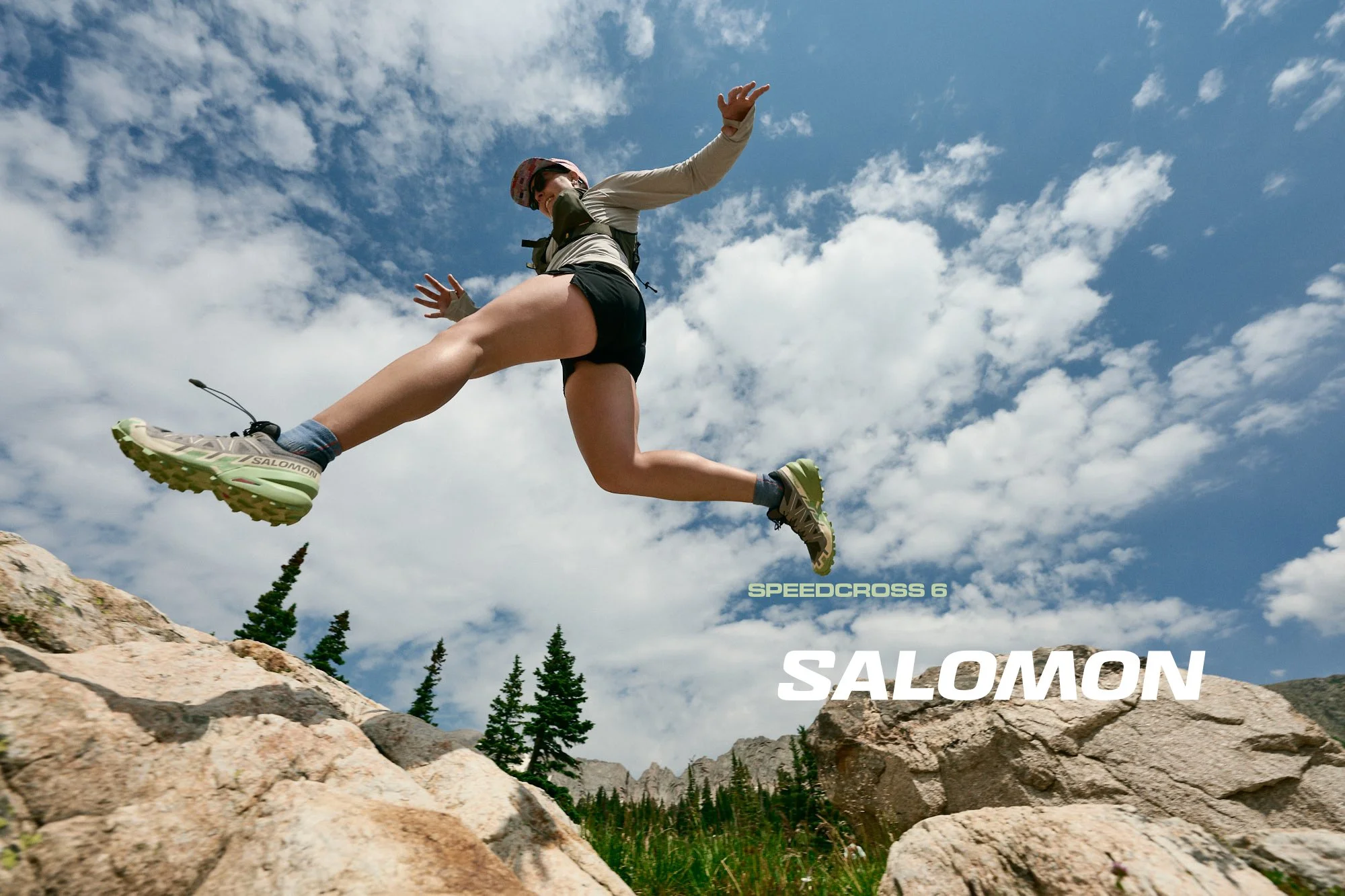 Runner in Salomon Speedcross 6 trail shoes jumping on a Colorado trail