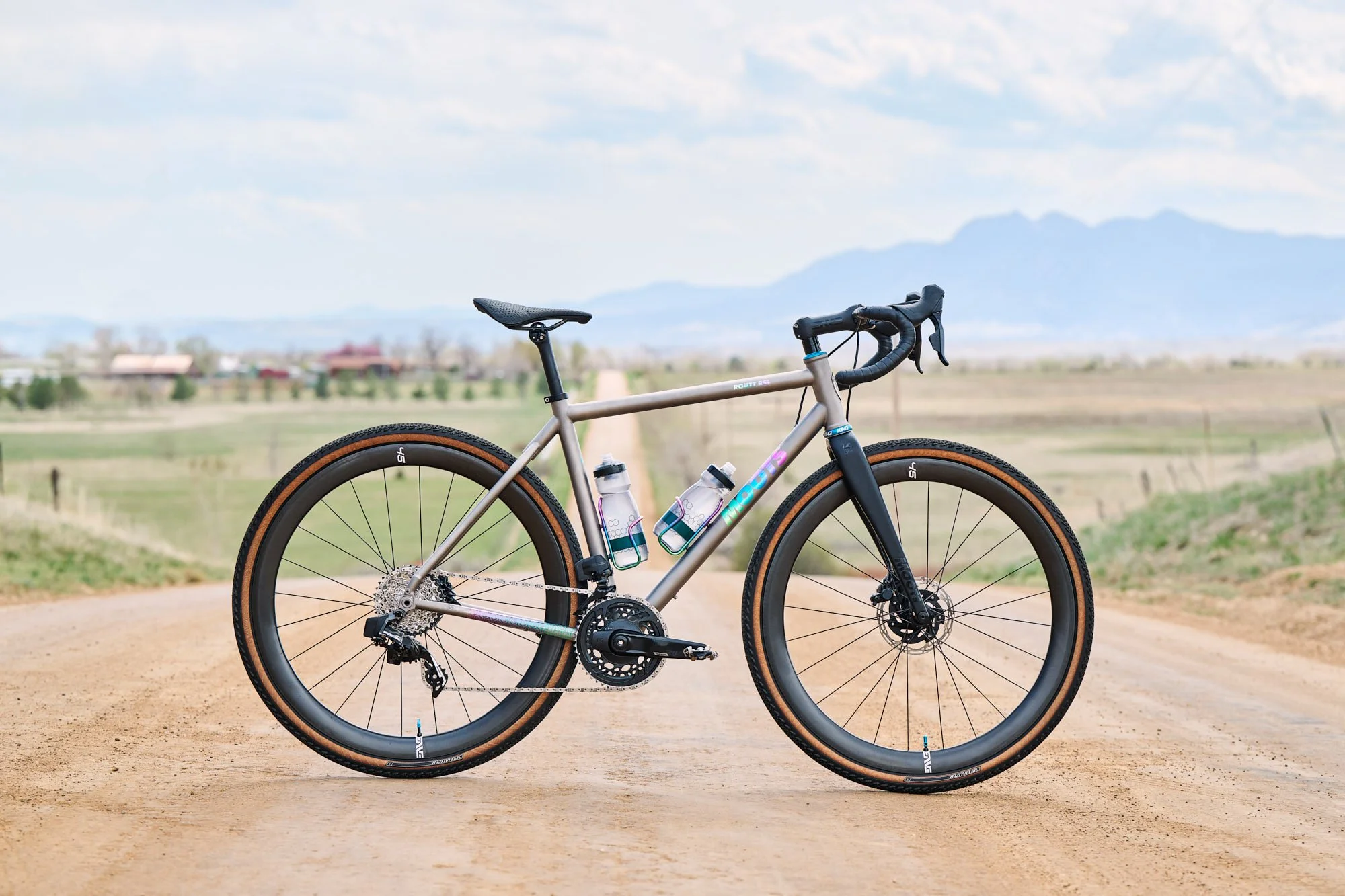 Titanium Moots Routt gravel bike in side profile on a Colorado farm road, bicycle campaign photography for Moots Cycles
